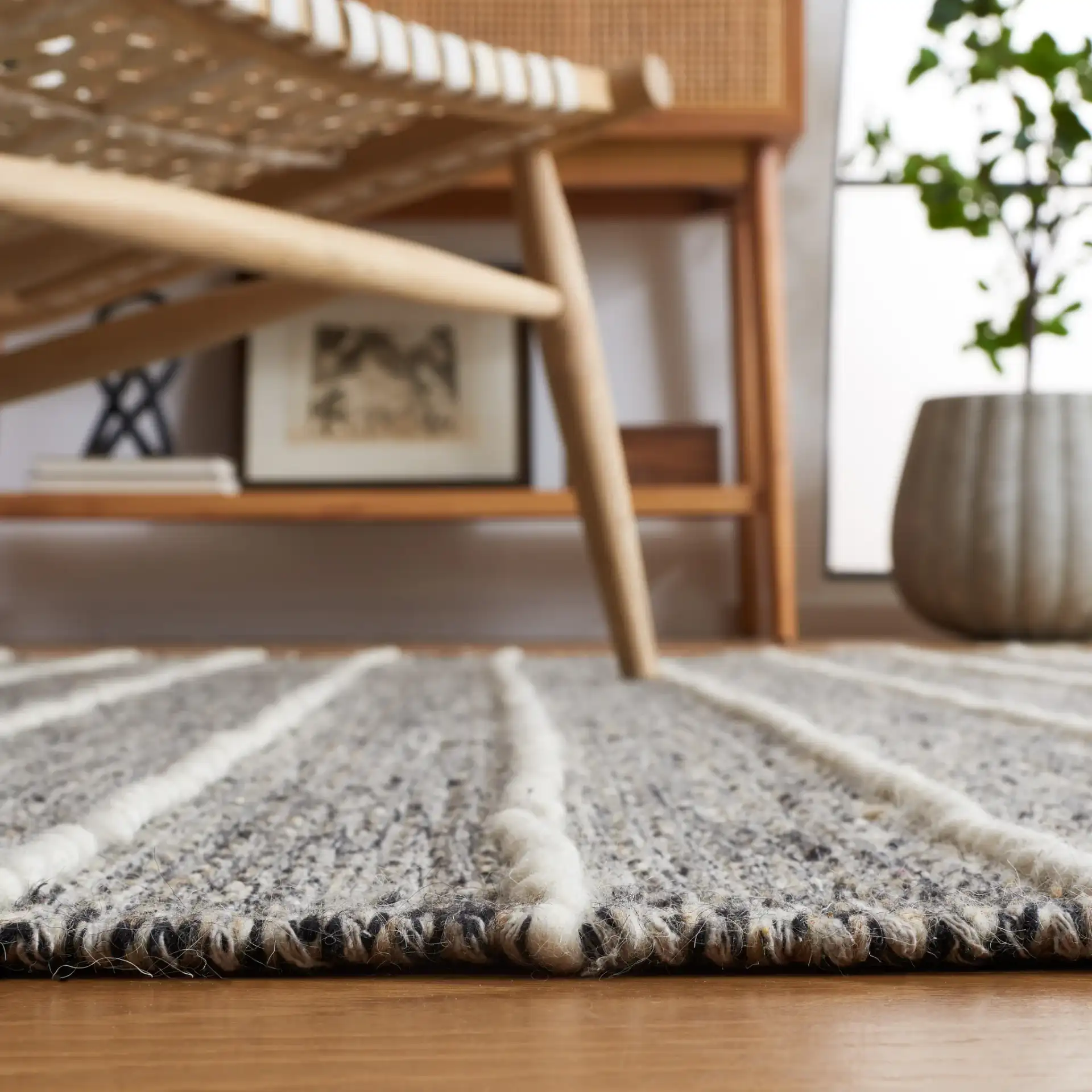 Vermont Striped Chevron Hand-Loomed Wool Rug in Black / Ivory in a styled room