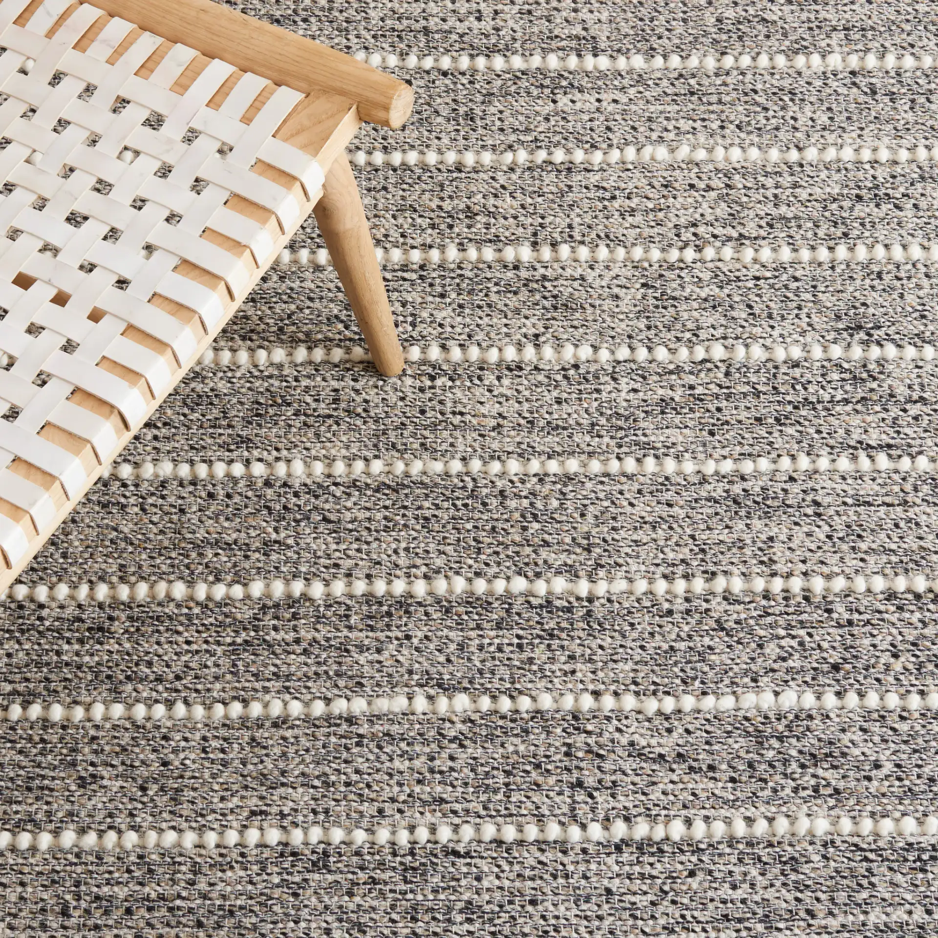 Vermont Striped Chevron Hand-Loomed Wool Rug in Black / Ivory in a styled room