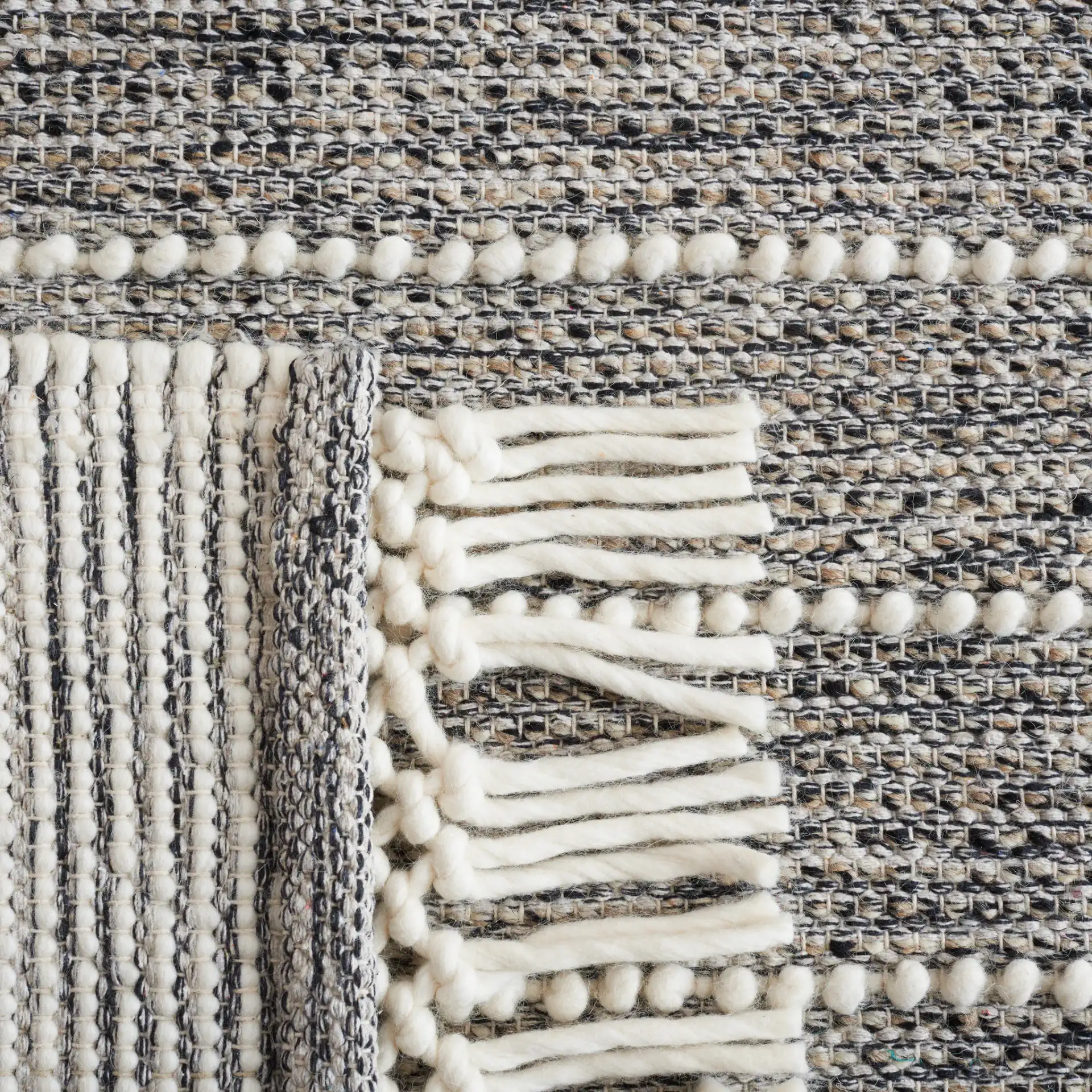 Vermont Striped Chevron Hand-Loomed Wool Rug in Black / Ivory in a styled room