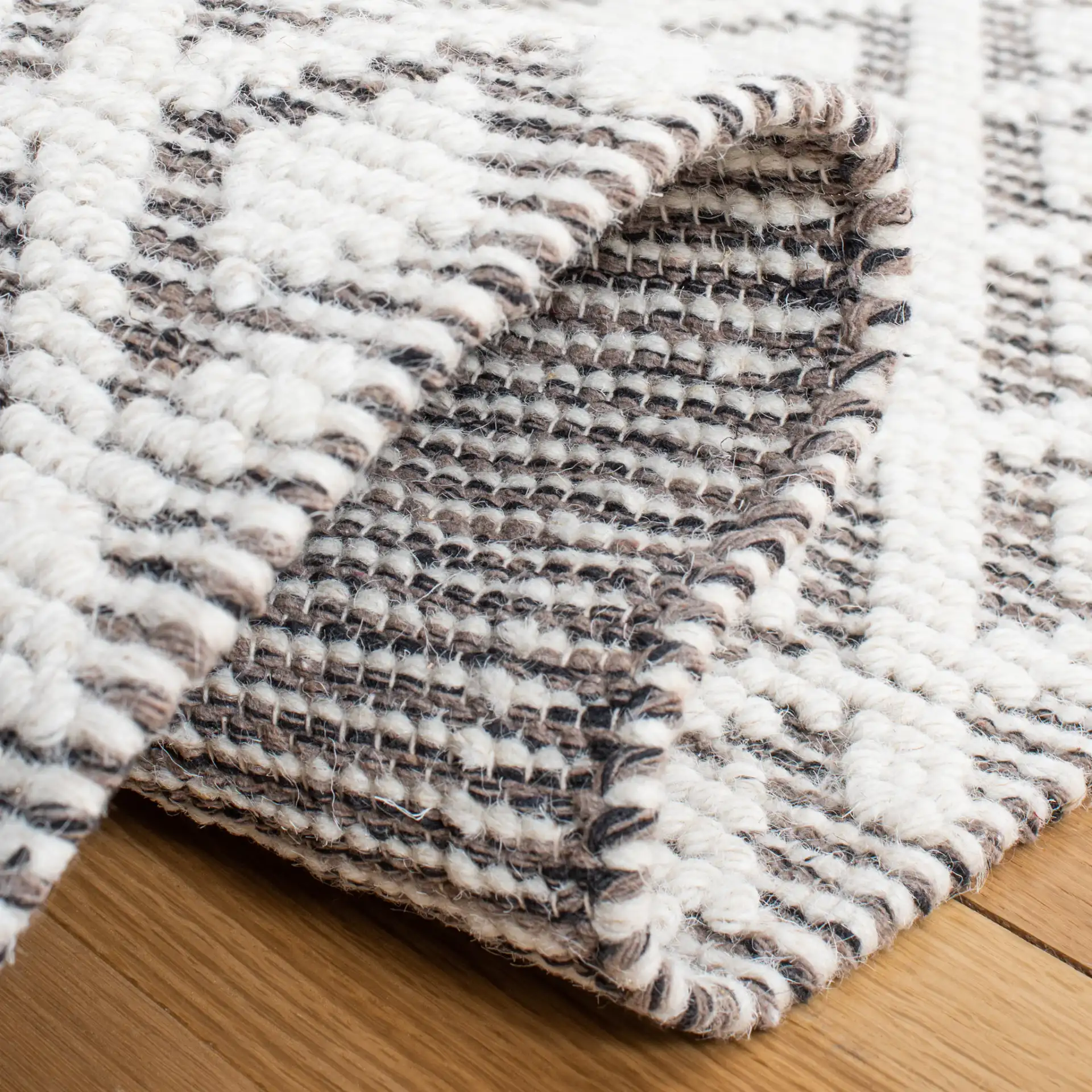 Vermont Diamond Lattice Hand-Woven Wool Rug in Ivory / Brown in a styled room