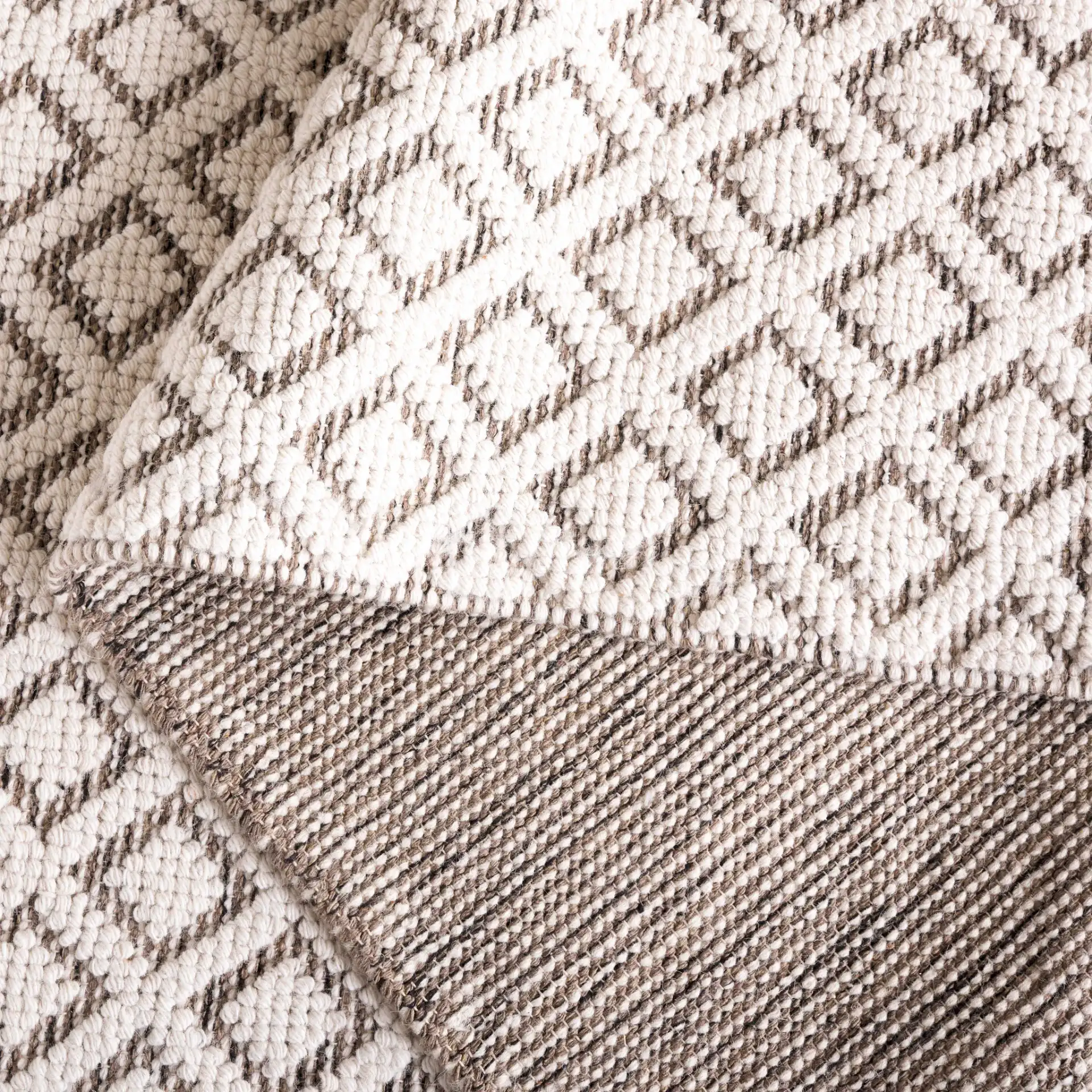Vermont Diamond Lattice Hand-Woven Wool Rug in Ivory / Brown in a styled room