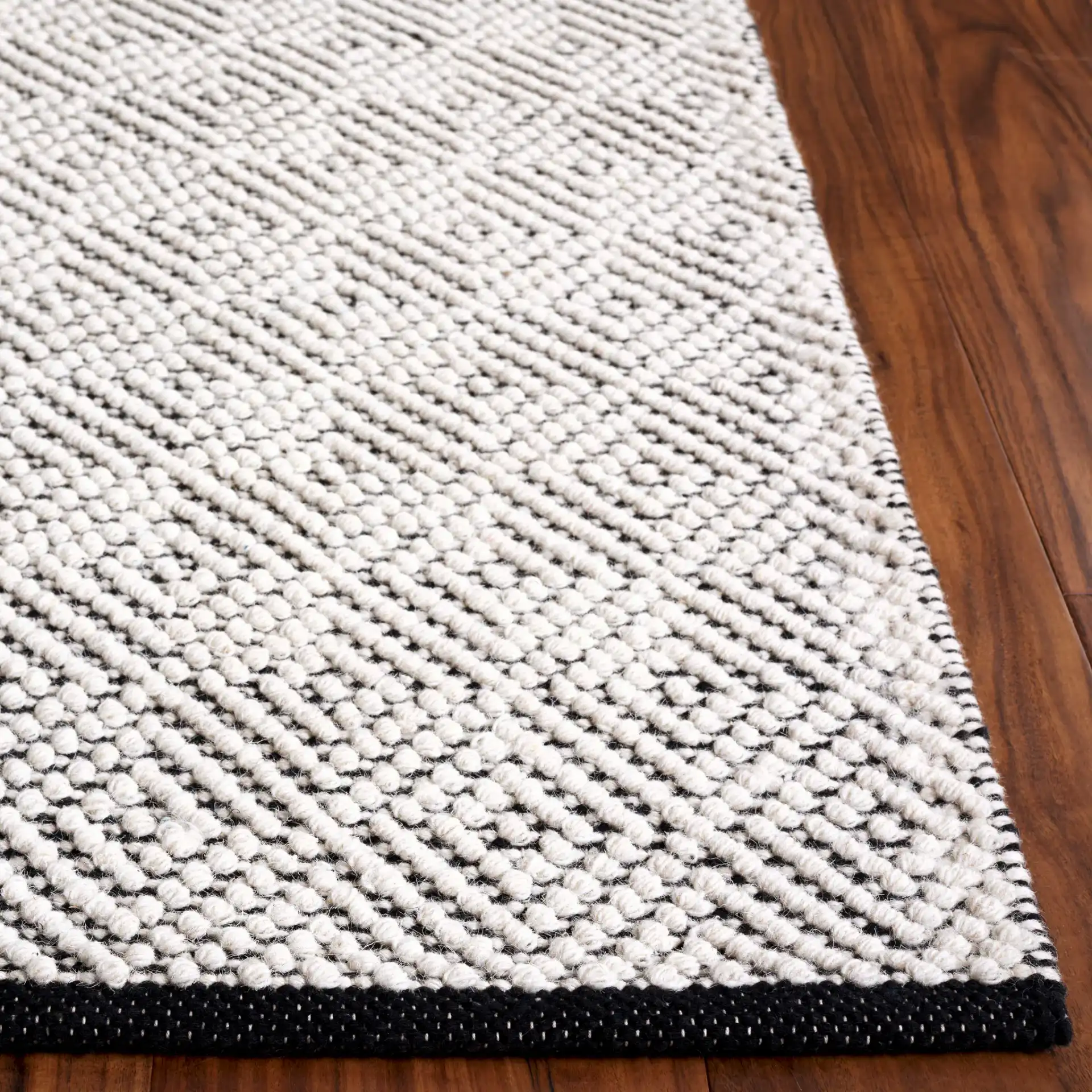 Vermont Micro Nested Diamond Hand-Woven Wool Rug in Ivory / Black in a styled room