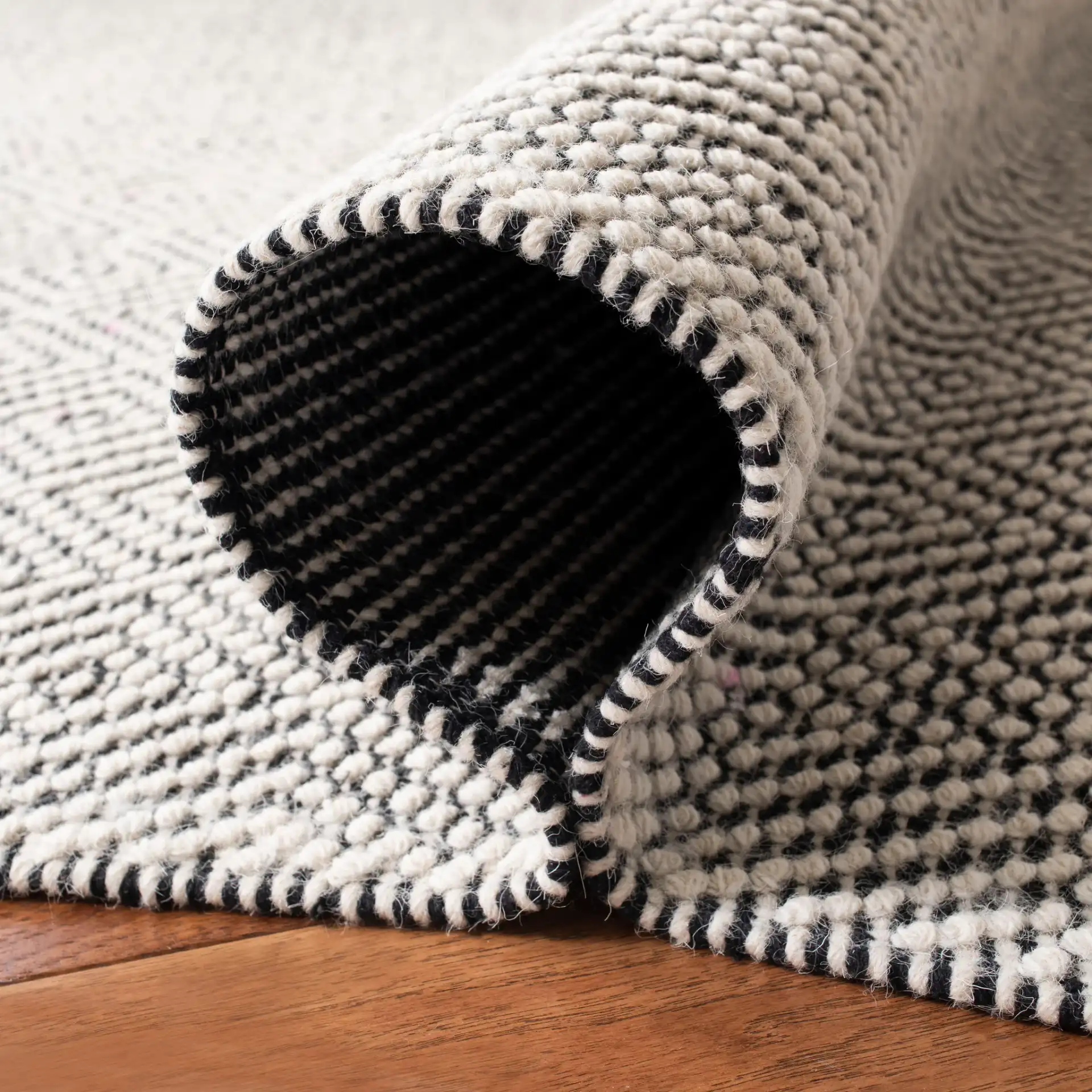 Vermont Micro Nested Diamond Hand-Woven Wool Rug in Ivory / Black in a styled room