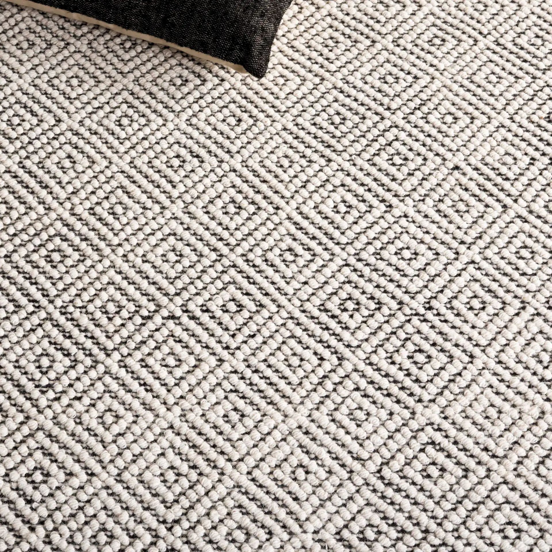 Vermont Micro Nested Diamond Hand-Woven Wool Rug in Ivory / Black in a styled room