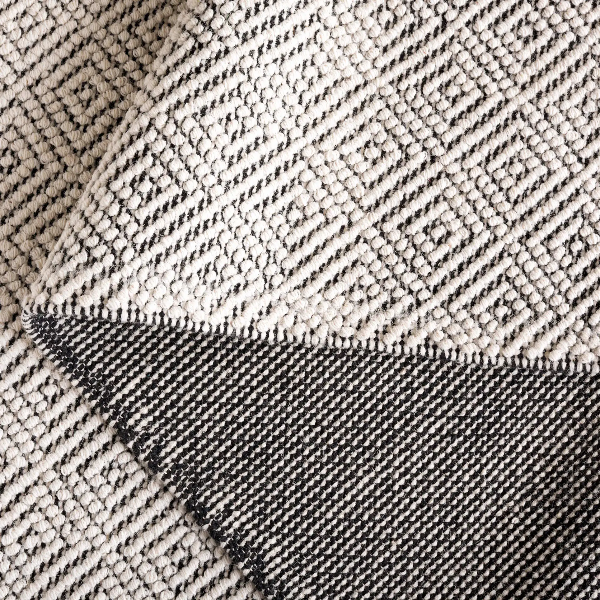 Vermont Micro Nested Diamond Hand-Woven Wool Rug in Ivory / Black in a styled room