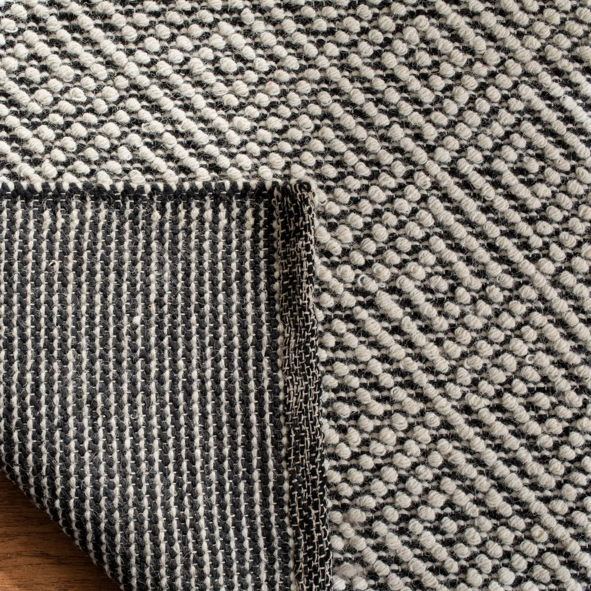 Vermont Micro Nested Diamond Hand-Woven Wool Rug in Ivory / Black in a styled room