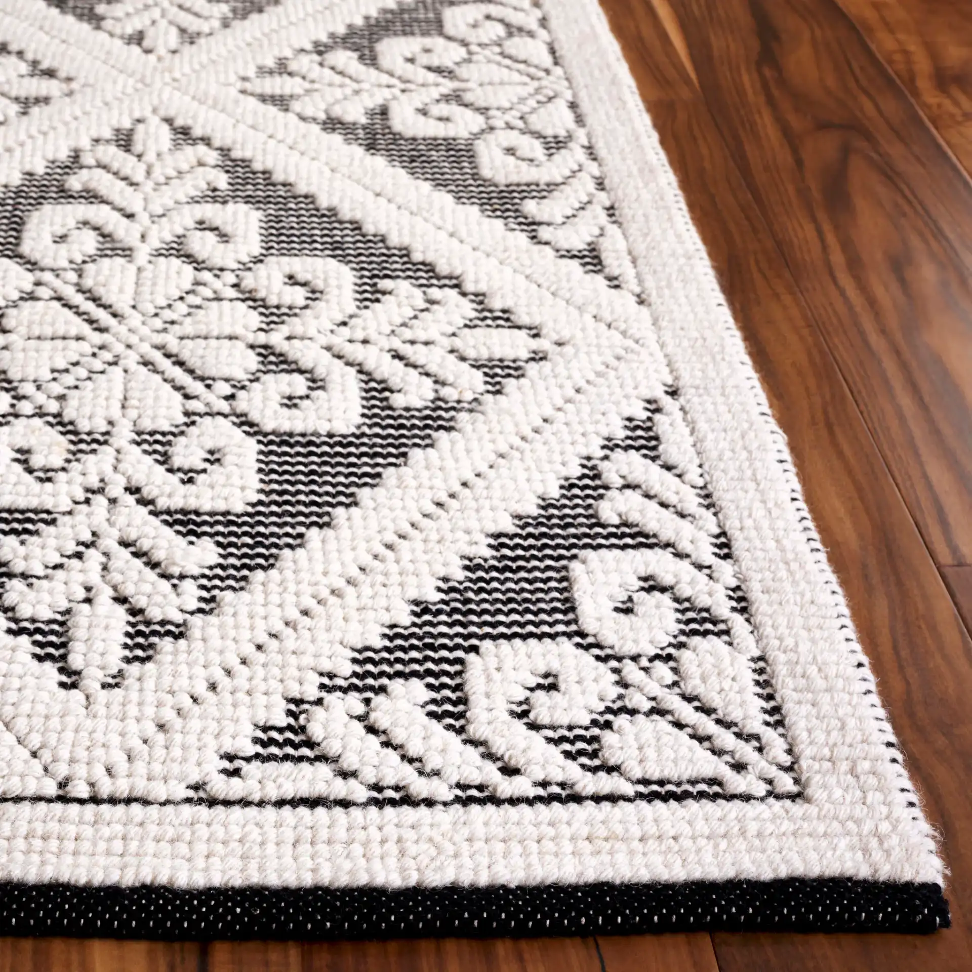 Vermont Floral Diamond Hand-Woven Wool Rug in Ivory / Black in a styled room