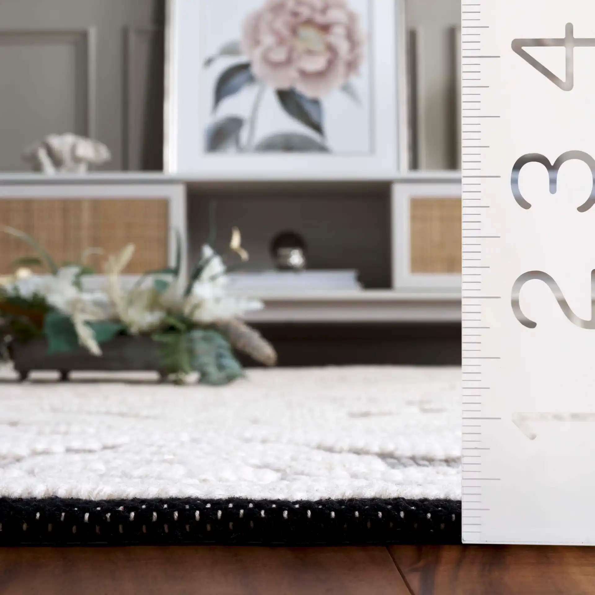 Vermont Floral Diamond Hand-Woven Wool Rug in Ivory / Black in a styled room