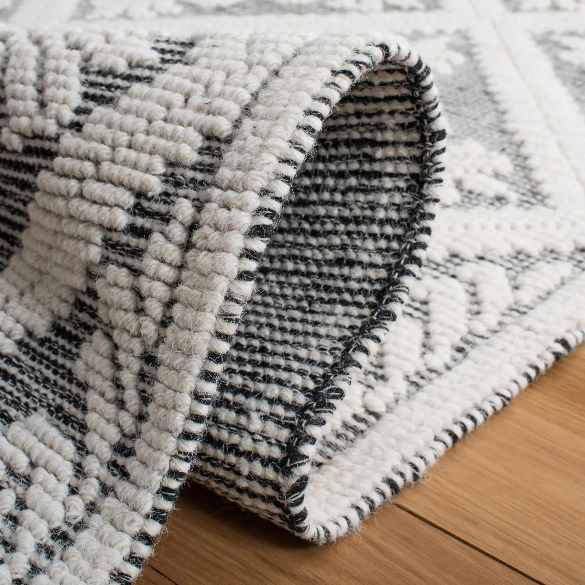 Vermont Floral Diamond Hand-Woven Wool Rug in Ivory / Black in a styled room