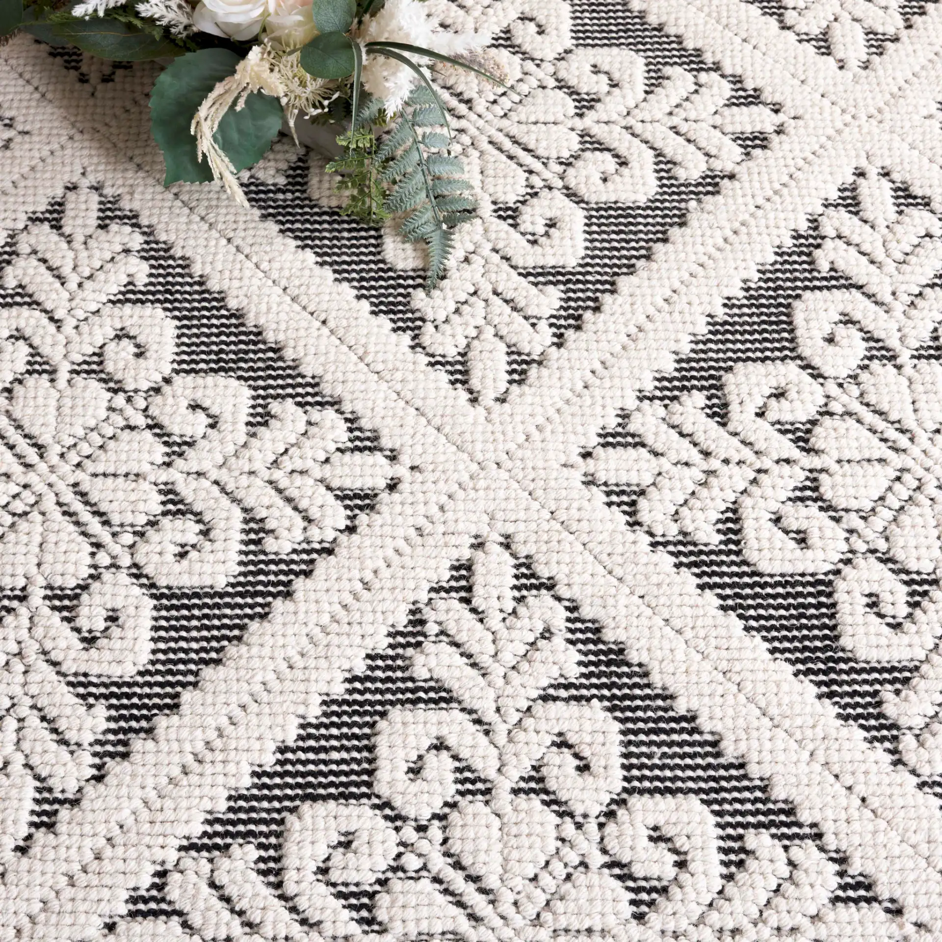 Vermont Floral Diamond Hand-Woven Wool Rug in Ivory / Black in a styled room