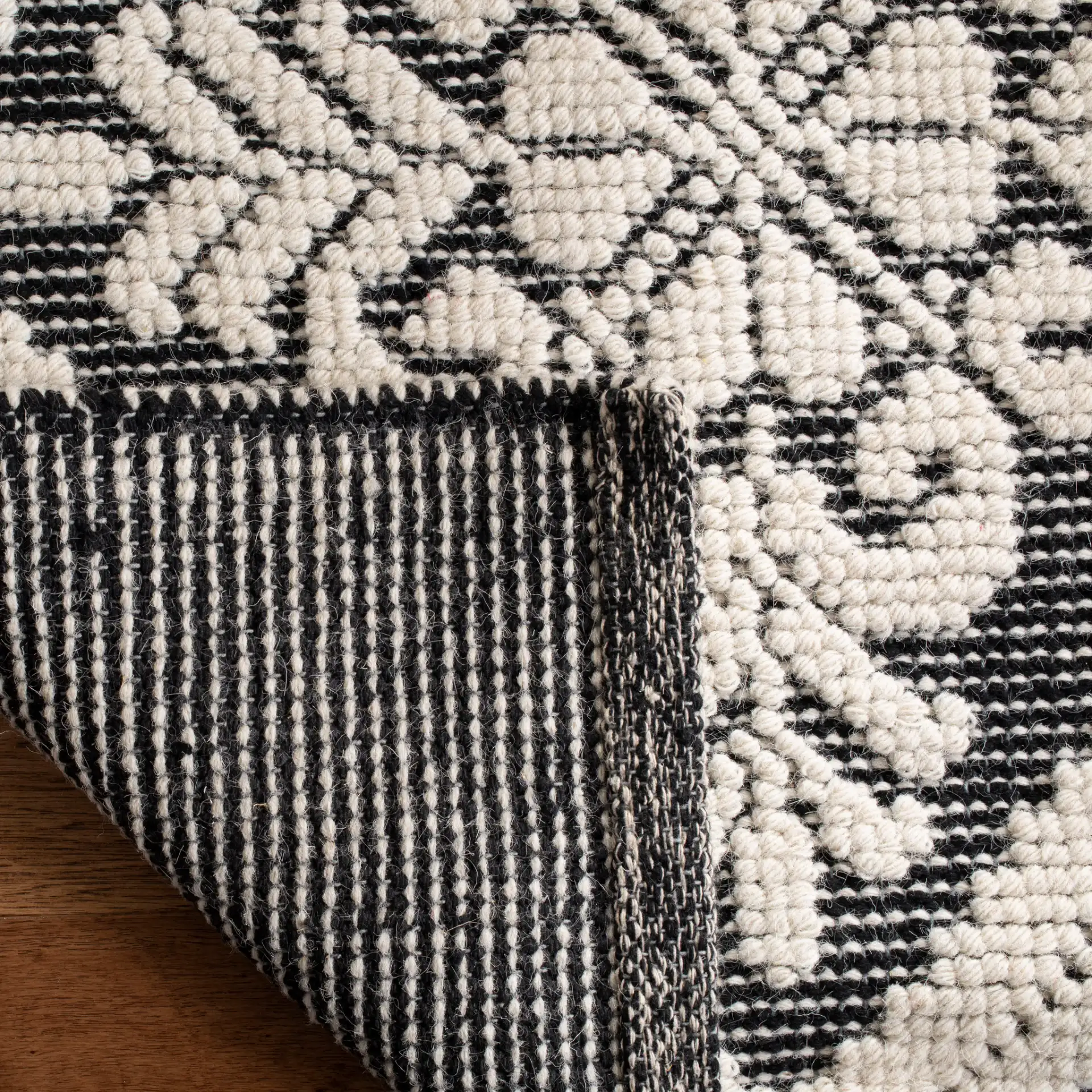 Vermont Floral Diamond Hand-Woven Wool Rug in Ivory / Black in a styled room