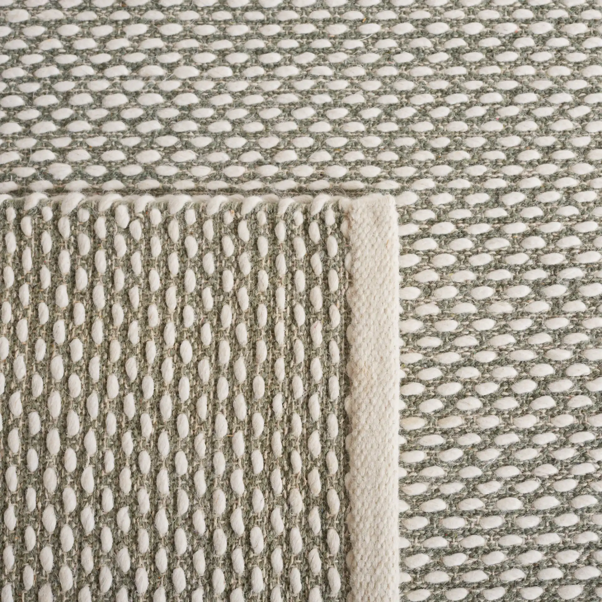 Vermont Textured Flatweave Wool Rug in Green in a styled room