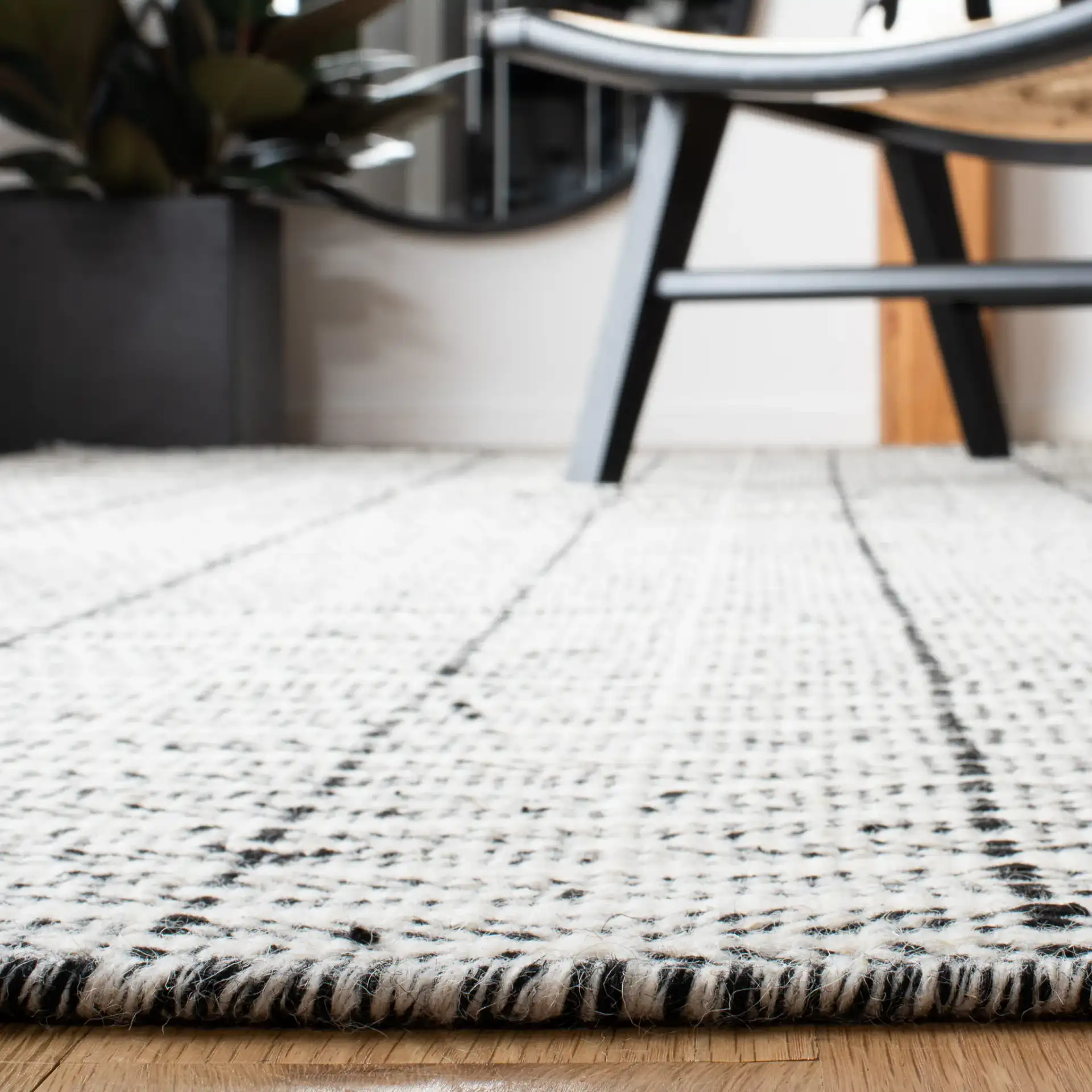 Vermont Chevron Hand-Tufted Wool Rug in Black / Ivory in a styled room