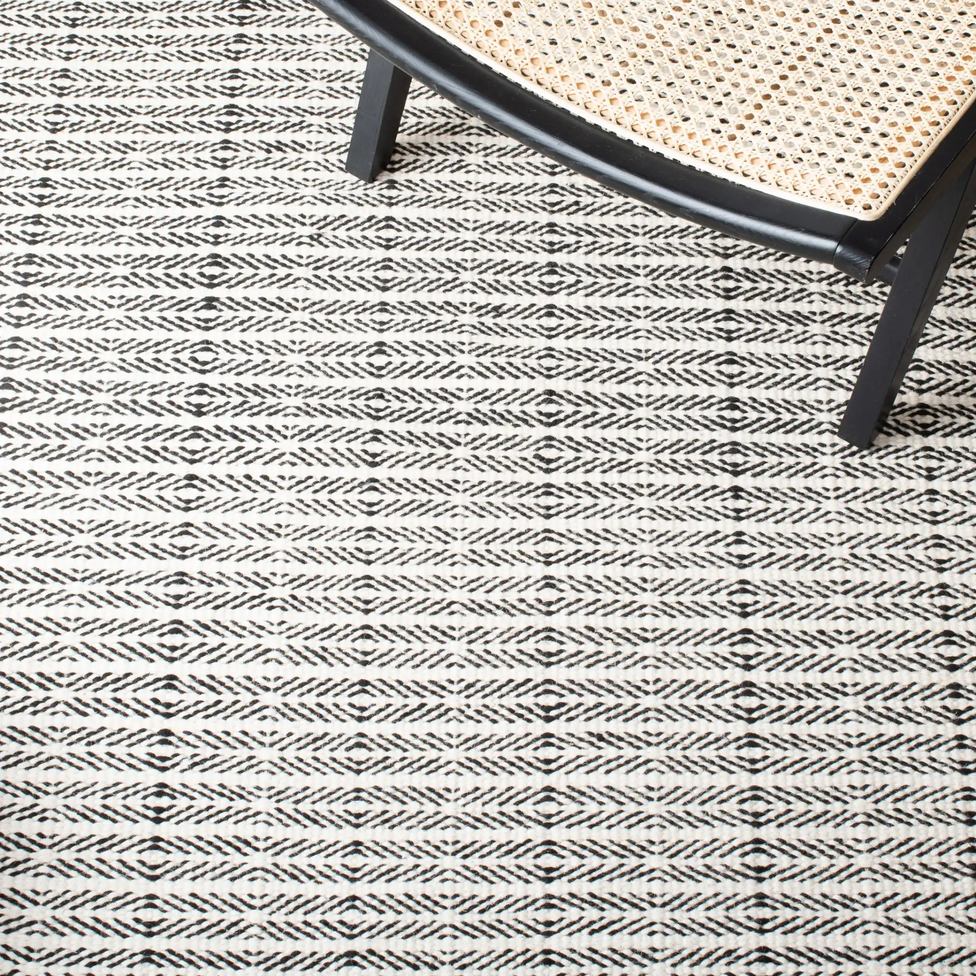 Vermont Chevron Hand-Tufted Wool Rug in Black / Ivory in a styled room