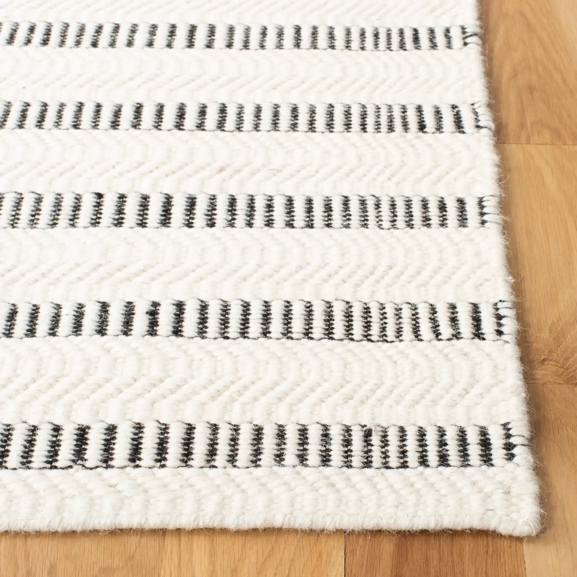 Vermont Stitched Stripe Hand-Tufted Wool Rug in Black / Ivory in a styled room