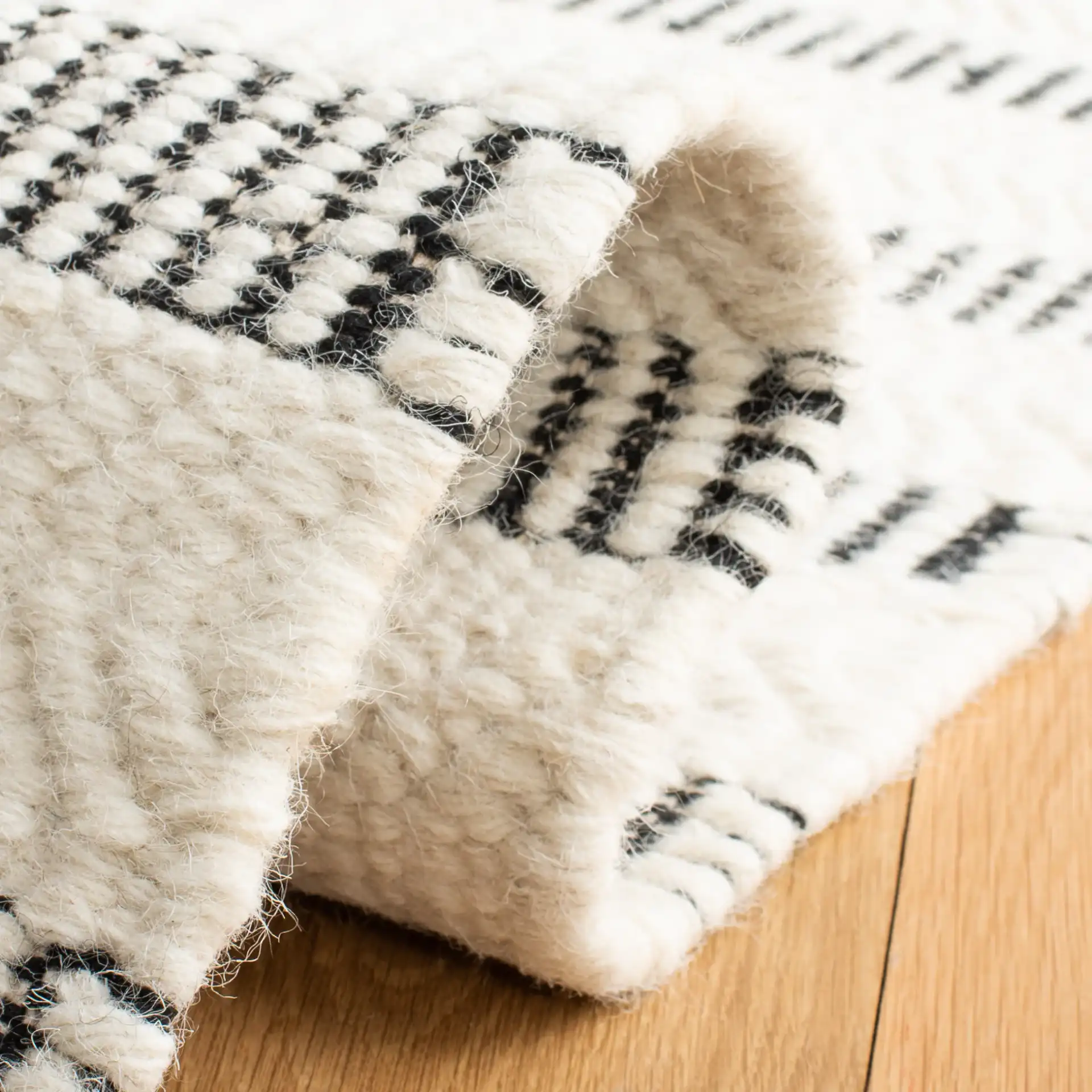 Vermont Stitched Stripe Hand-Tufted Wool Rug in Black / Ivory in a styled room