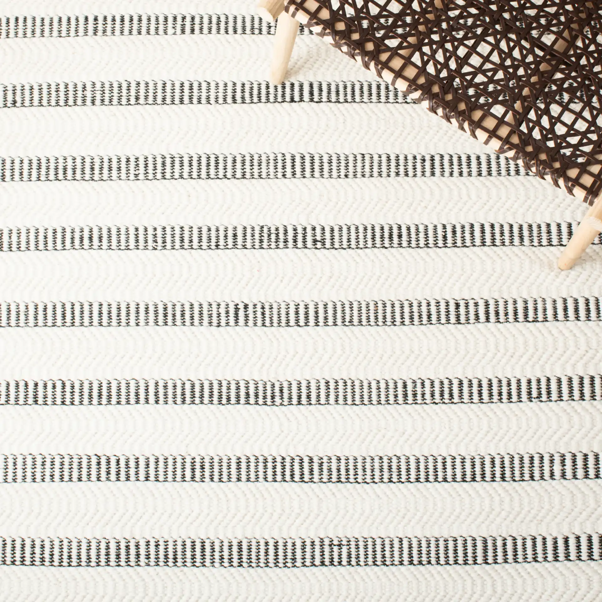 Vermont Stitched Stripe Hand-Tufted Wool Rug in Black / Ivory in a styled room