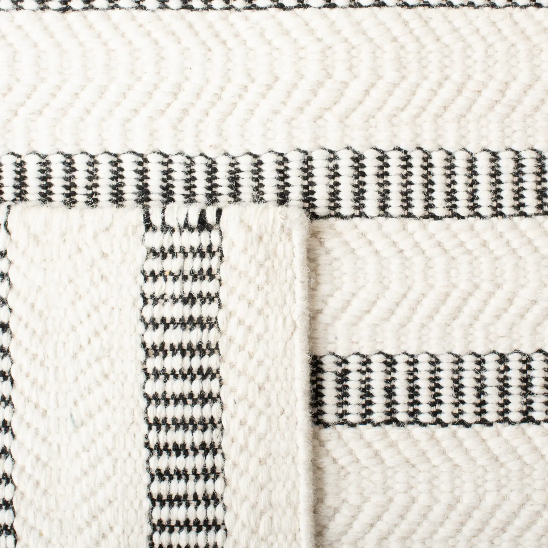 Vermont Stitched Stripe Hand-Tufted Wool Rug in Black / Ivory in a styled room