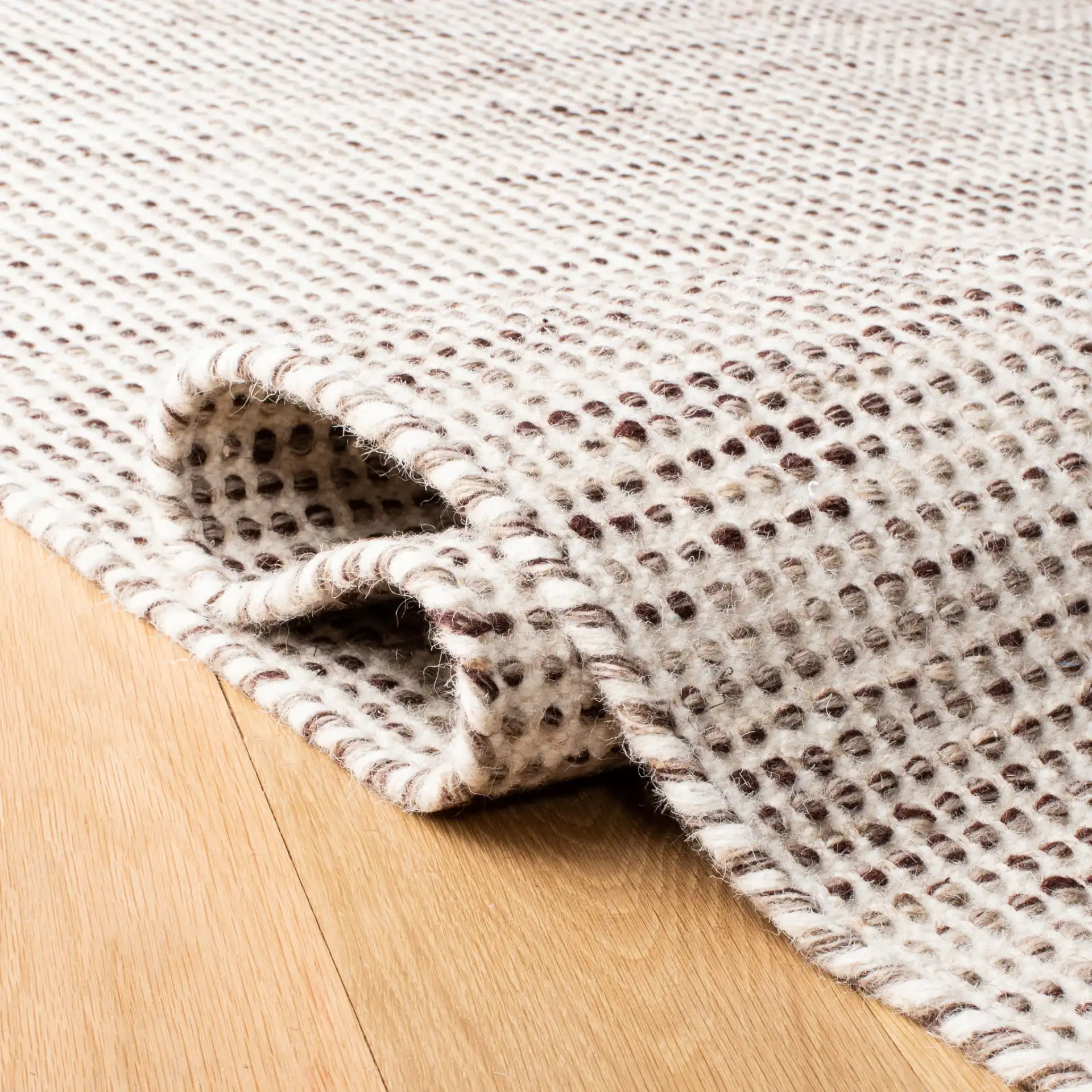 Vermont Textured Grid Hand-Tufted Wool Rug in Brown / Ivory in a styled room