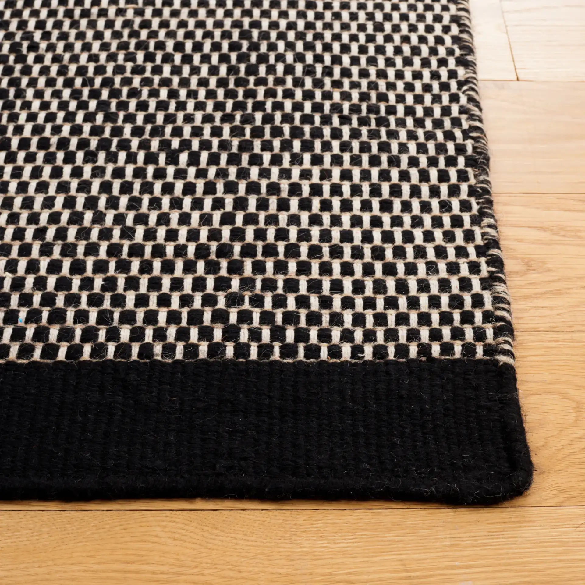 Vermont Basketweave Hand-Woven Wool Rug in Black in a styled room