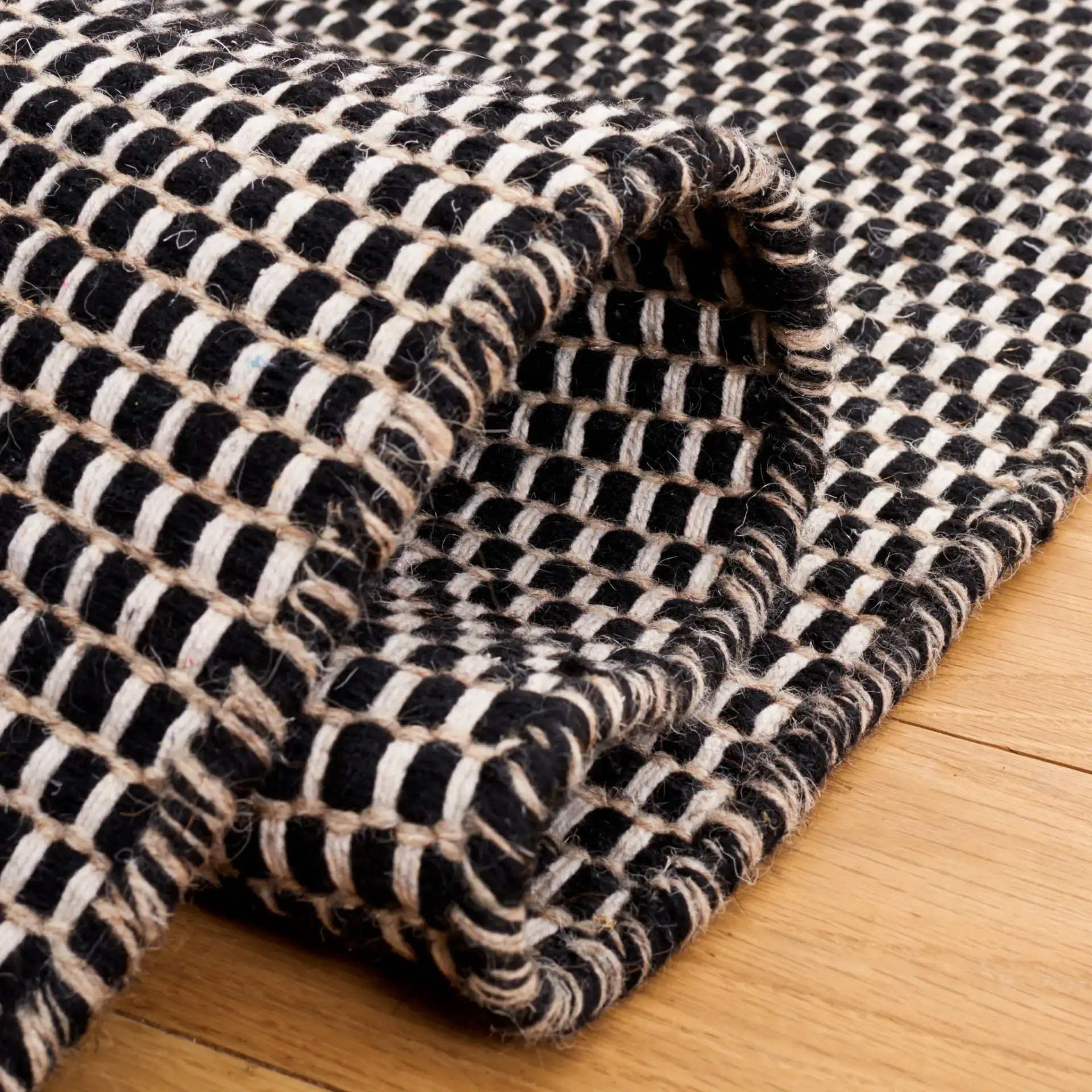 Vermont Basketweave Hand-Woven Wool Rug in Black in a styled room