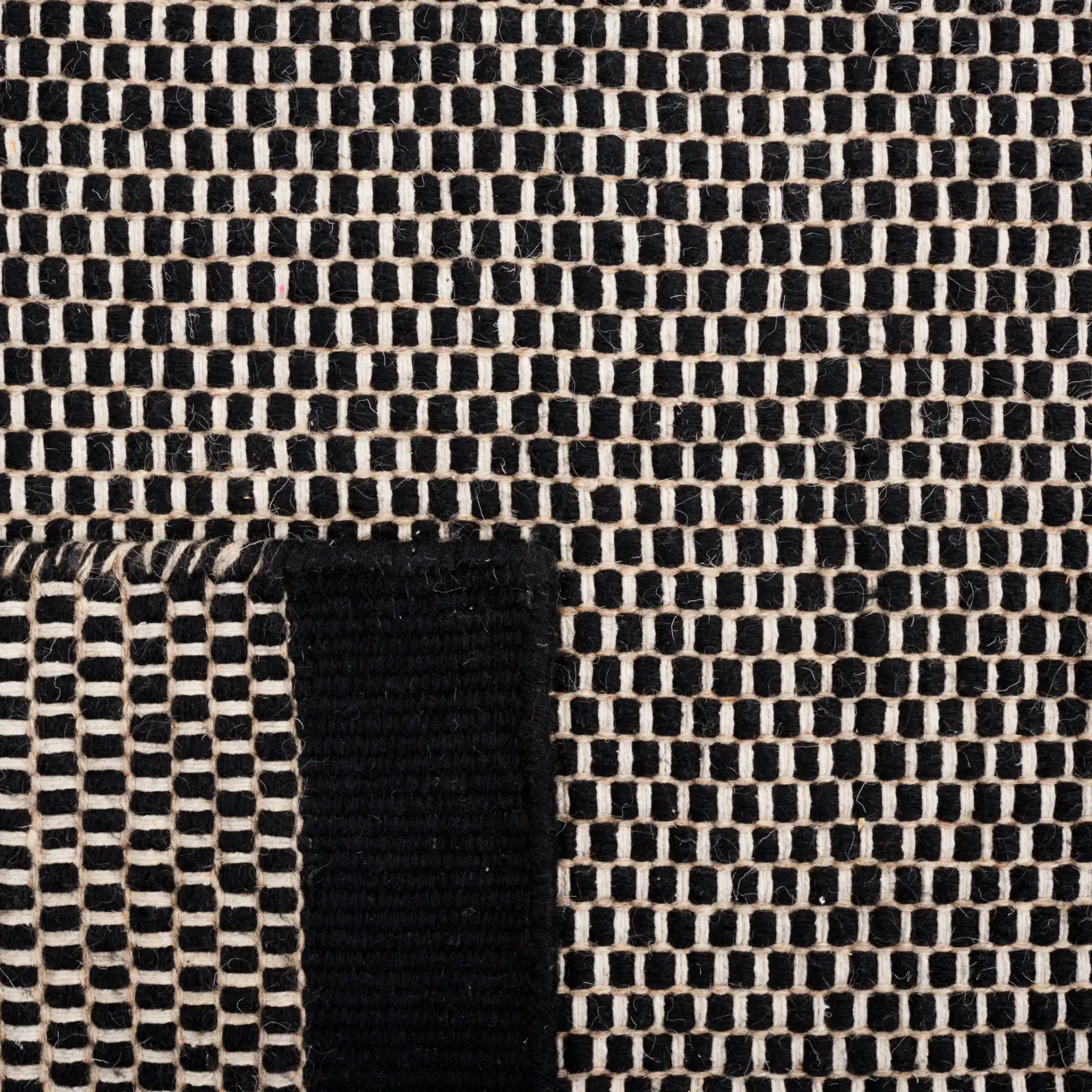 Vermont Basketweave Hand-Woven Wool Rug in Black in a styled room