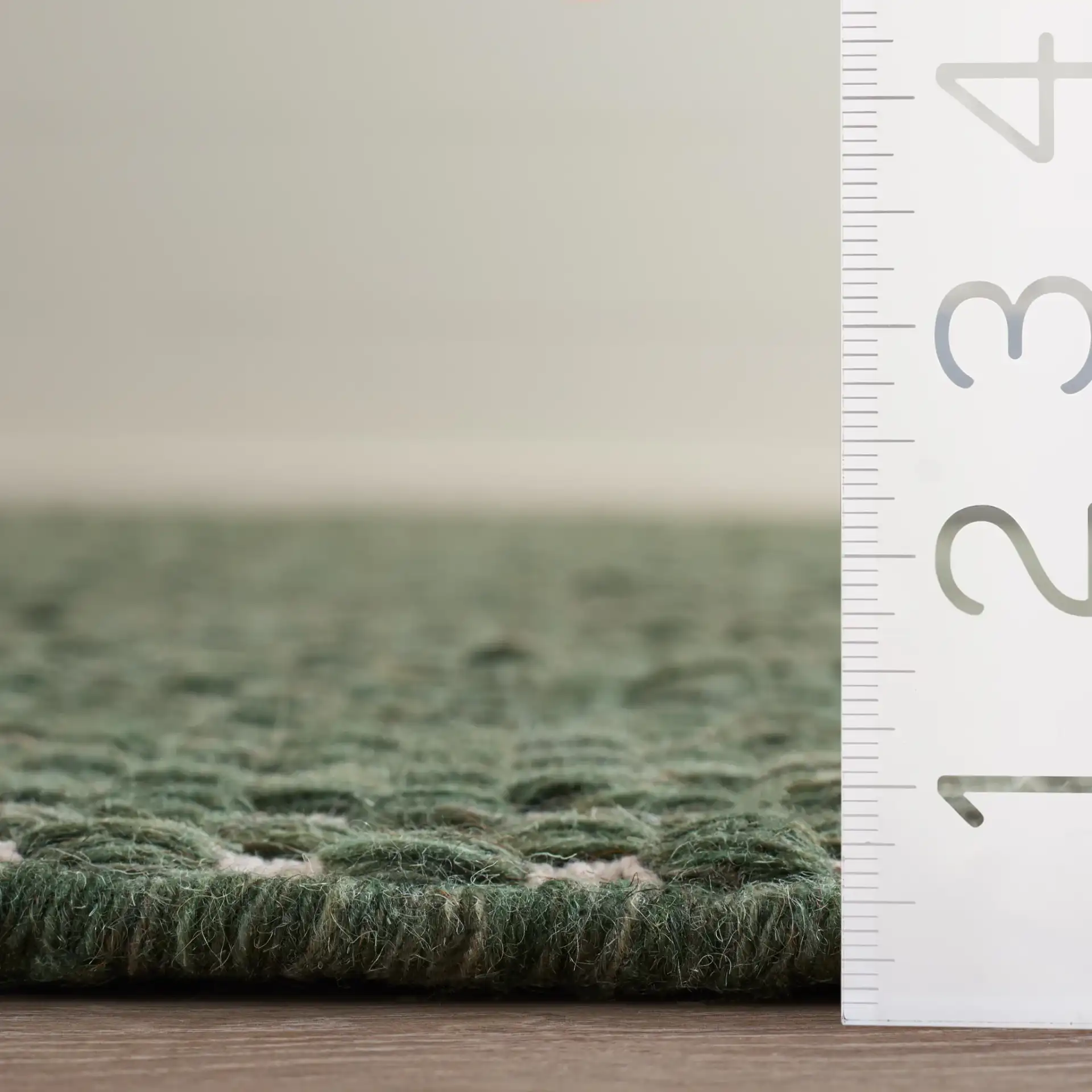 Vermont Pebbled Flatweave Wool Rug in Green / Ivory in a styled room