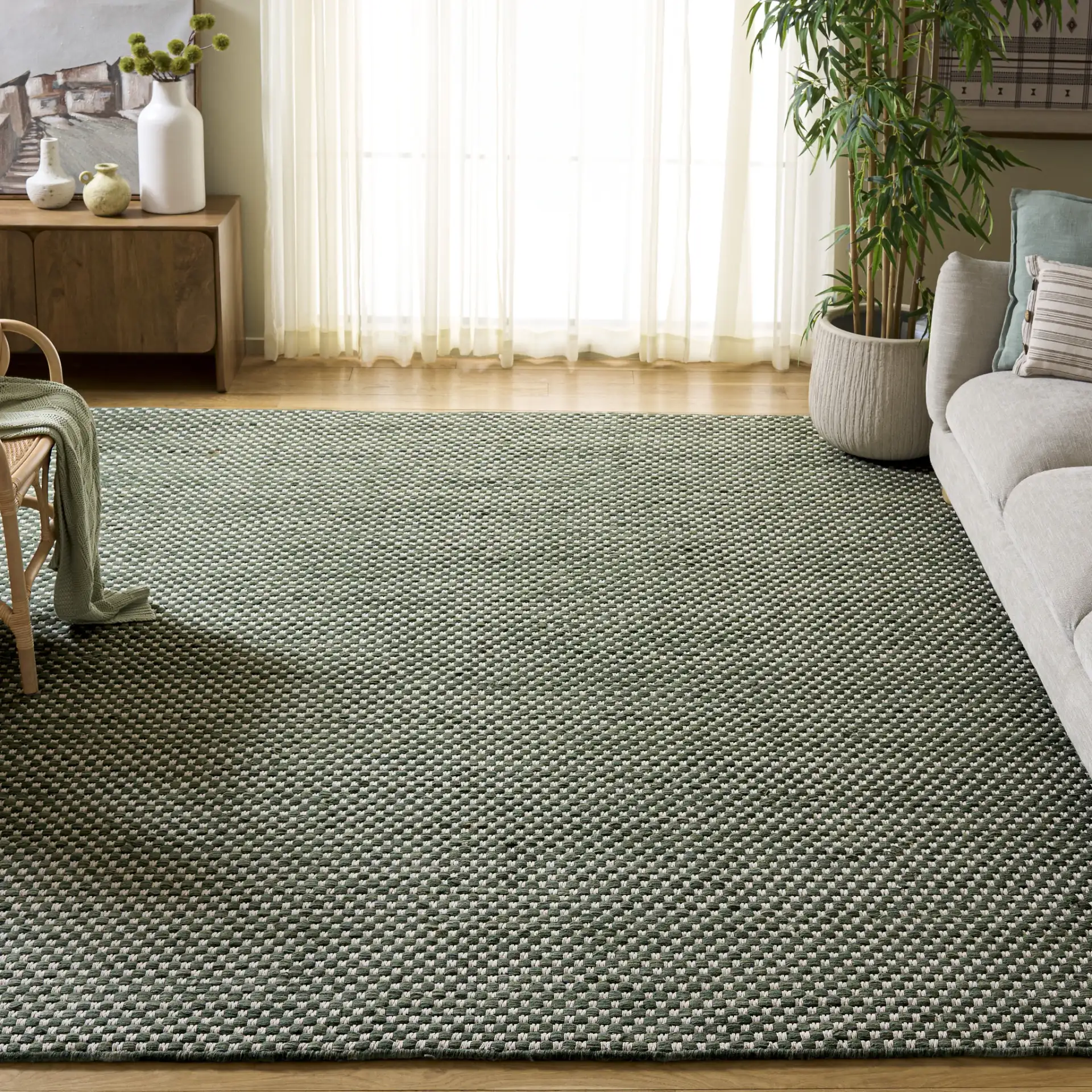 Vermont Pebbled Flatweave Wool Rug in Green / Ivory in a styled room