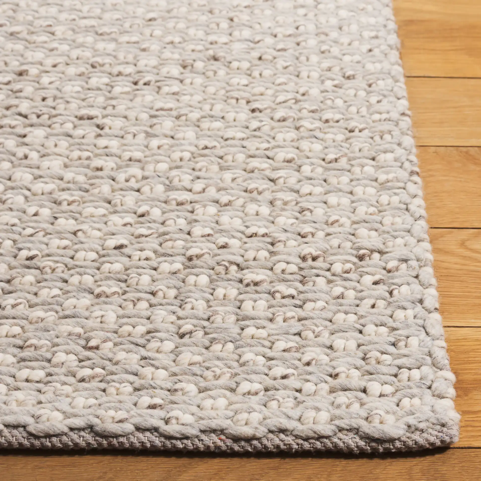 Vermont Pebbled Solid Hand-Woven Rug in Silver / Ivory in a styled room