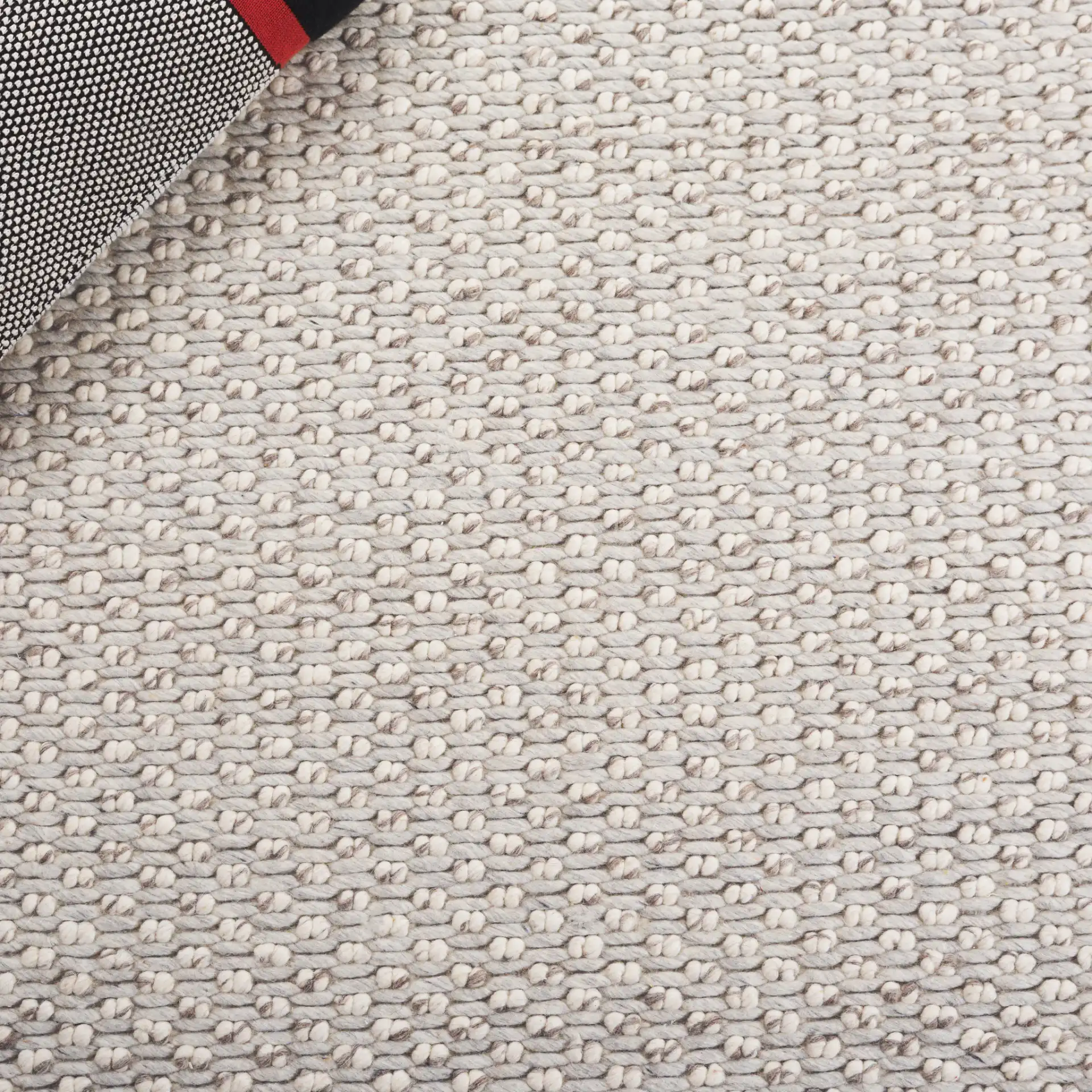 Vermont Pebbled Solid Hand-Woven Rug in Silver / Ivory in a styled room