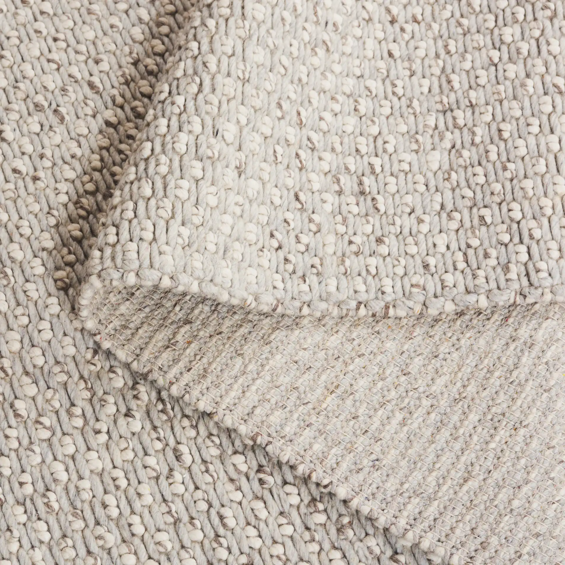 Vermont Pebbled Solid Hand-Woven Rug in Silver / Ivory in a styled room