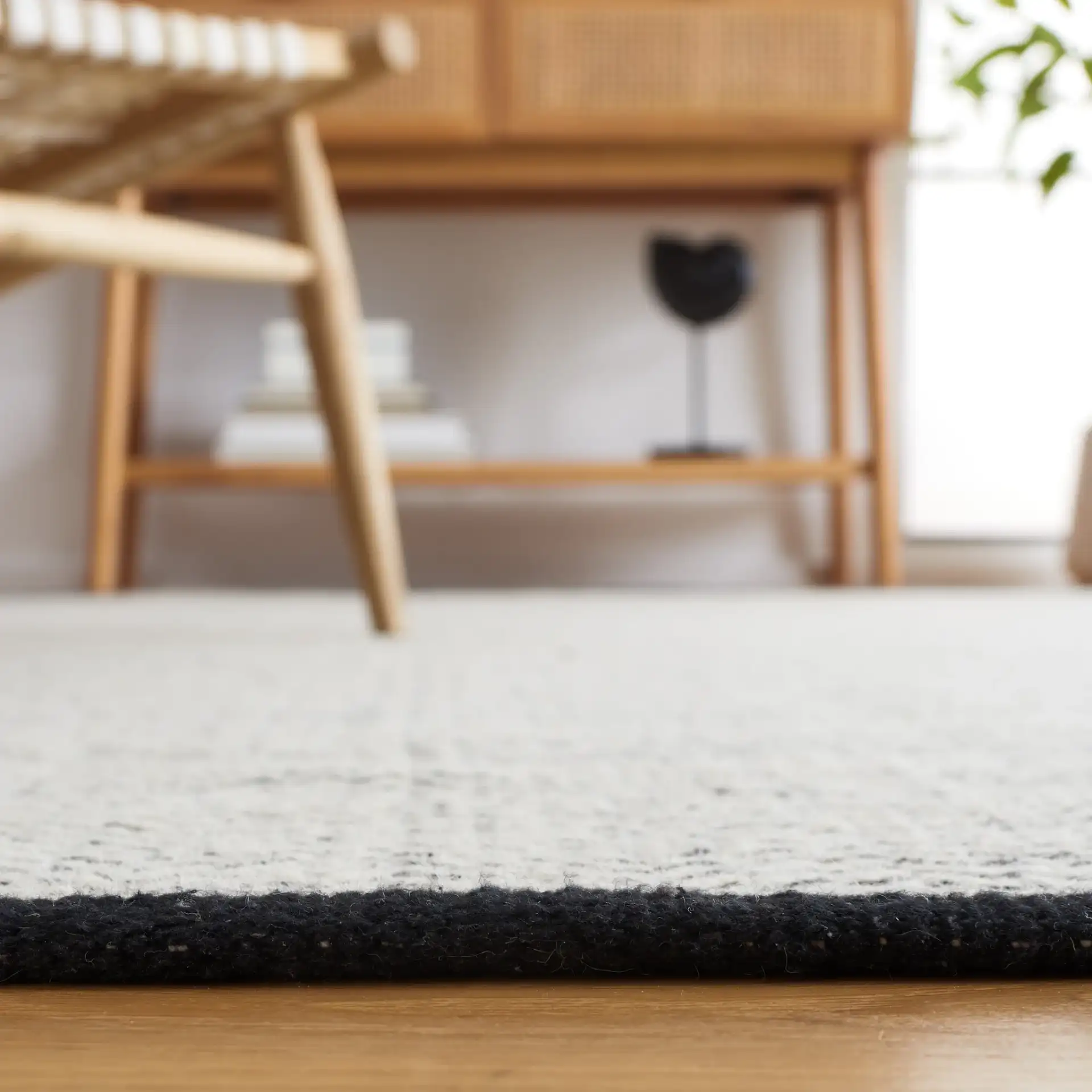 Vermont Chevron Hand-Woven Wool Rug in Black / Ivory in a styled room