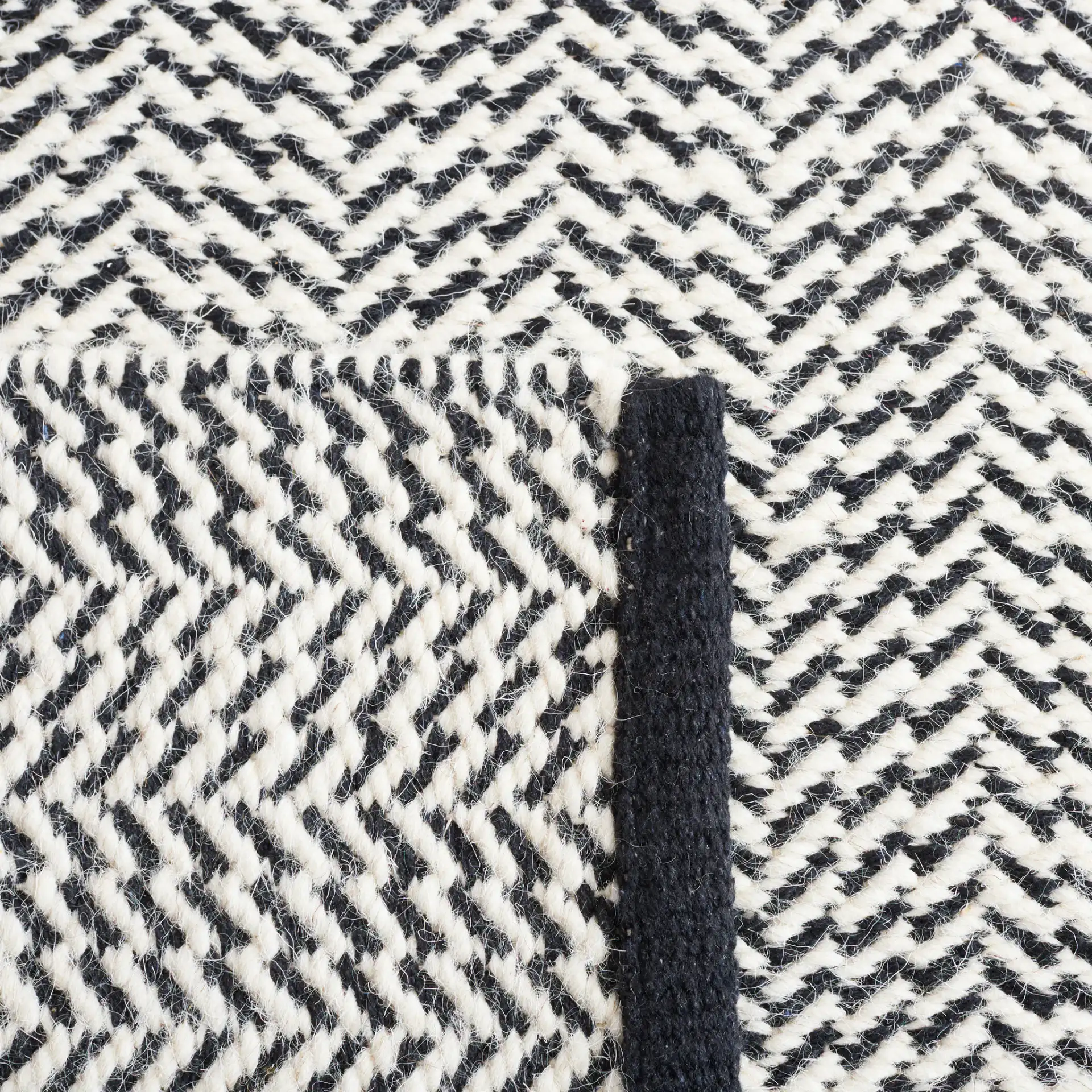 Vermont Chevron Hand-Woven Wool Rug in Black / Ivory in a styled room