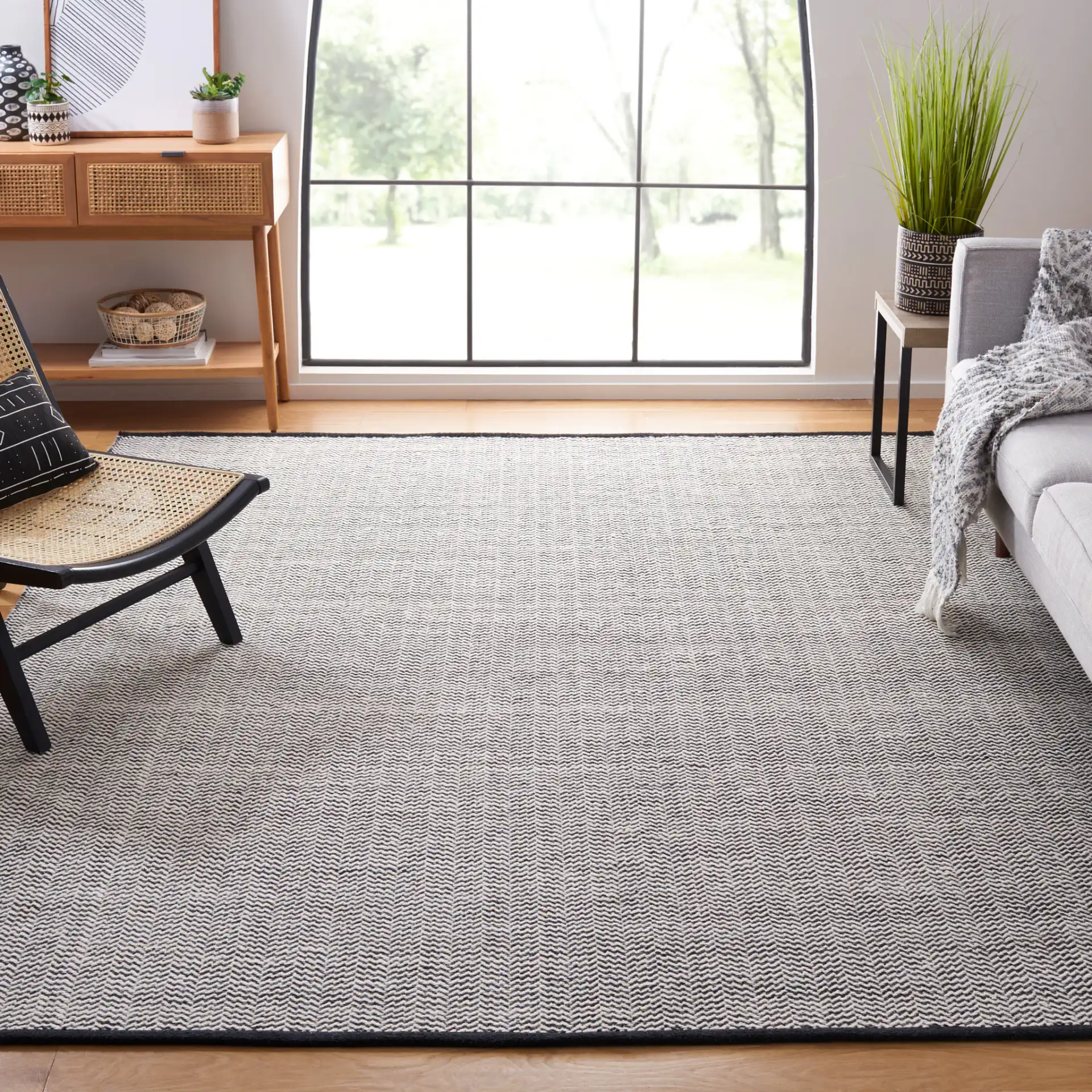 Vermont Chevron Hand-Woven Wool Rug in Black / Ivory in a styled room
