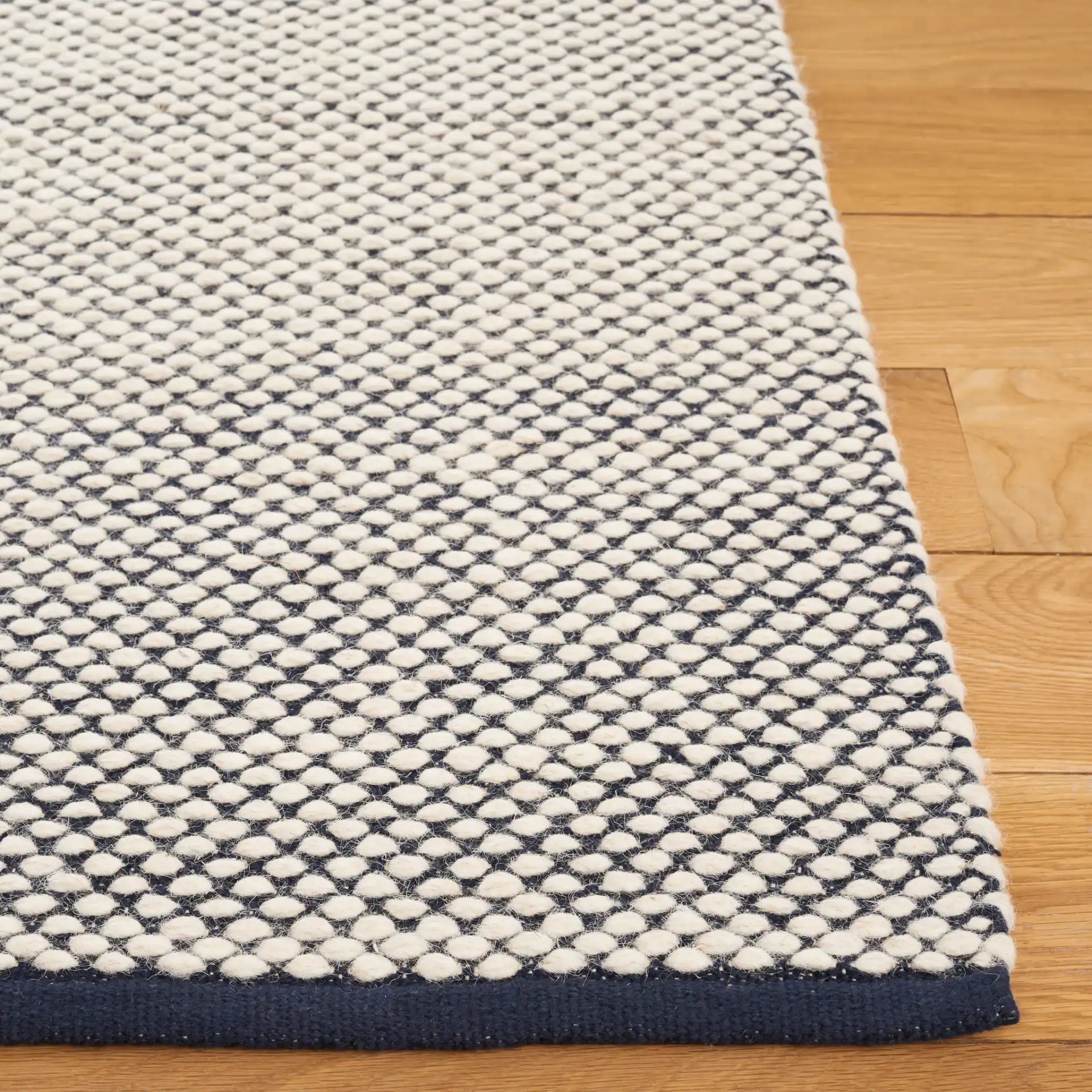 Vermont Heathered Flatweave Wool Rug in Navy / Ivory in a styled room