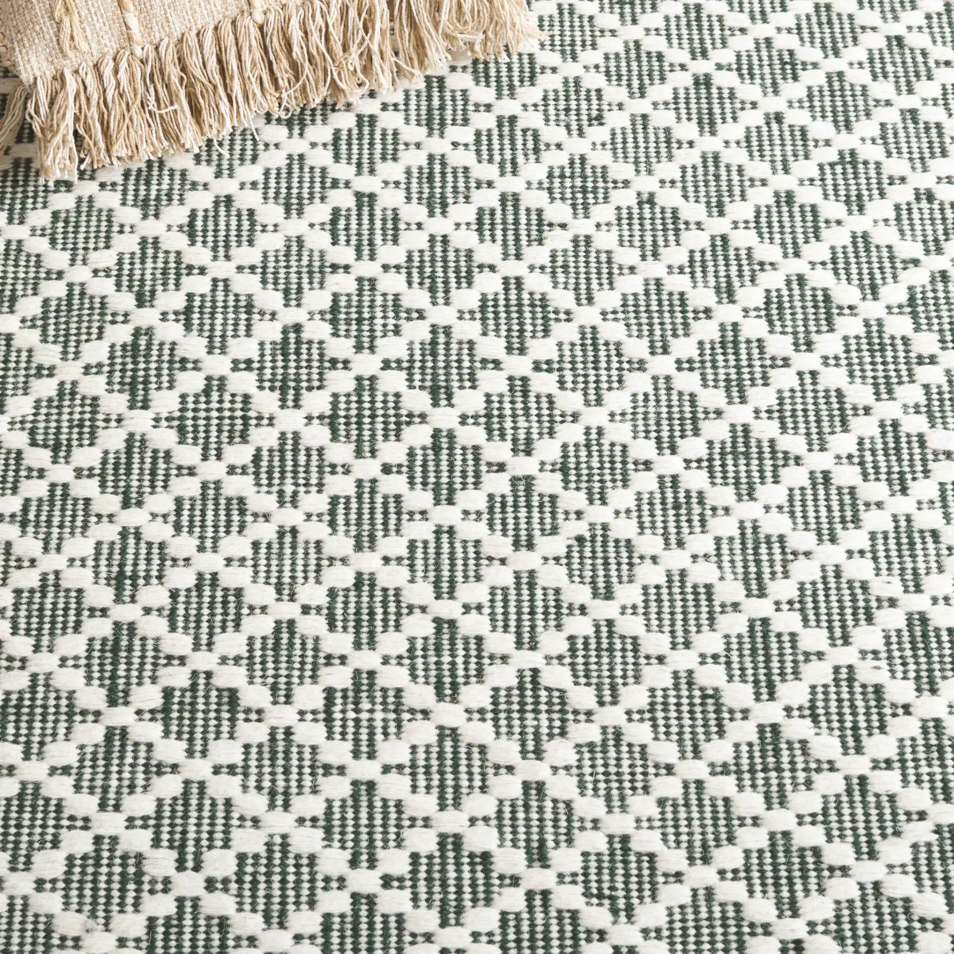 Vermont Micro Diamond Hand-Woven Wool Rug in Green / Ivory in a styled room