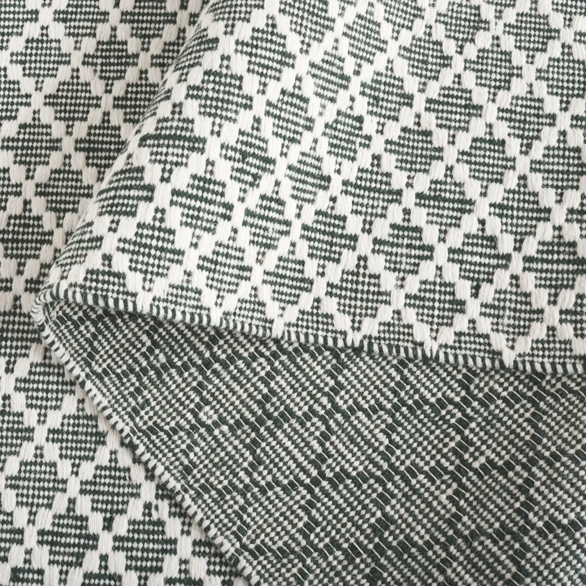 Vermont Micro Diamond Hand-Woven Wool Rug in Green / Ivory in a styled room