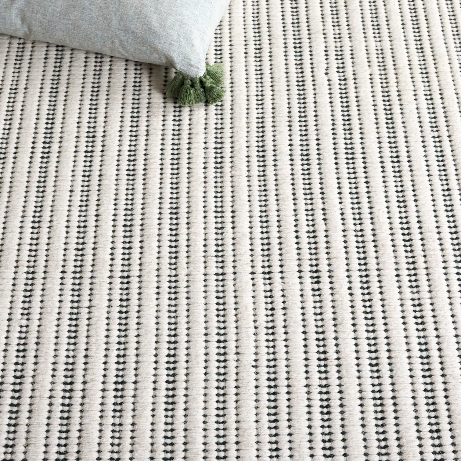 Vermont Pinstripe Hand-Woven Rug in Green / Ivory in a styled room