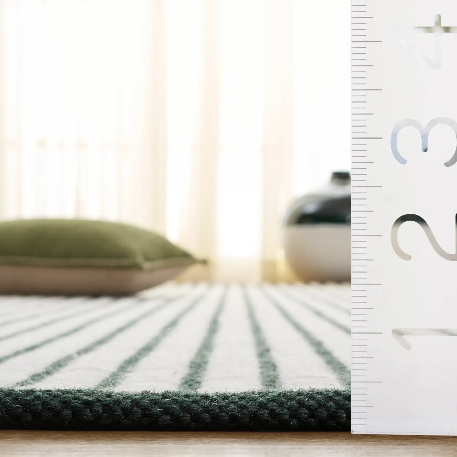 Vermont Pinstripe Hand-Woven Wool Rug in Dark Green / Ivory in a styled room