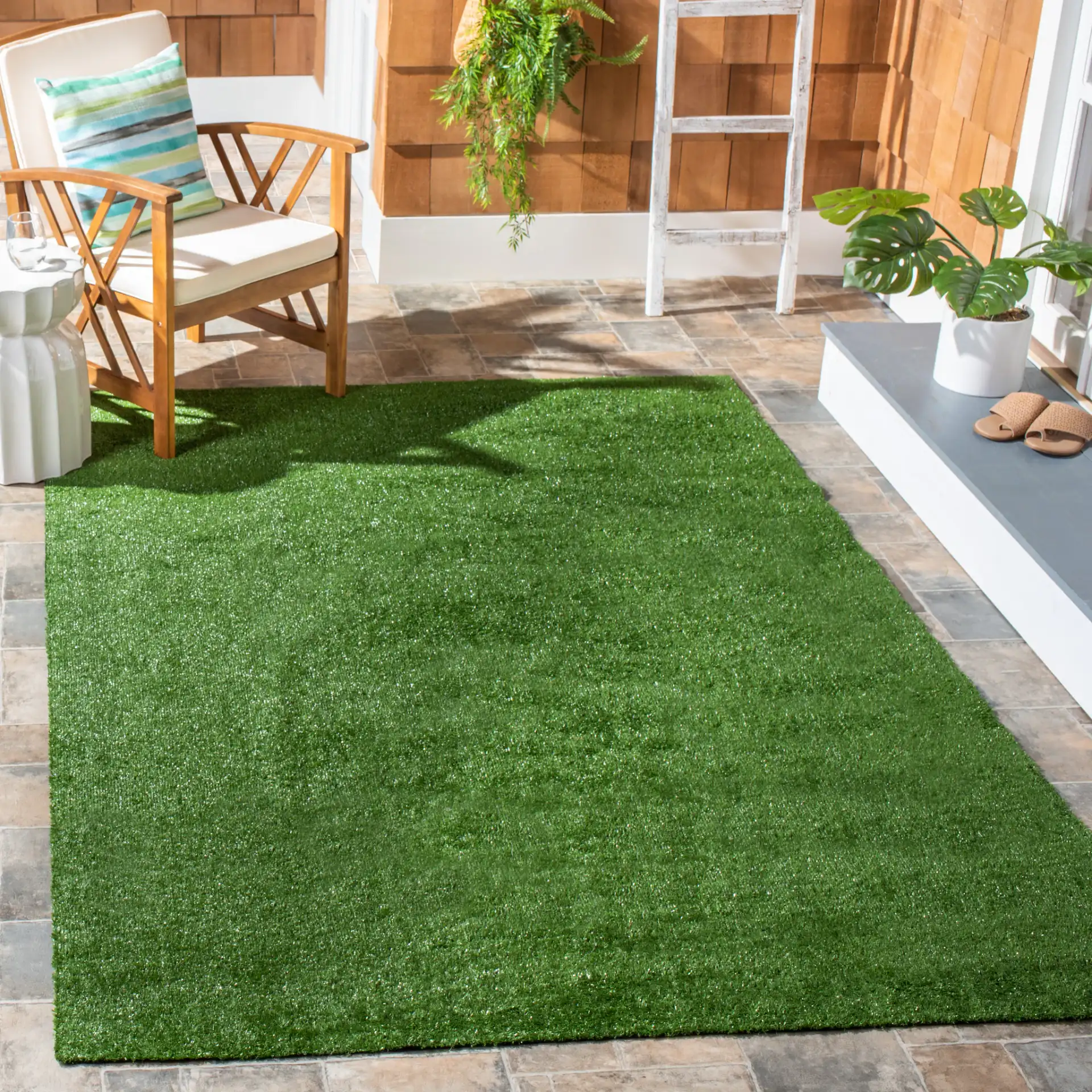Turf Solid Runner Outdoor Rug in Green in a styled room