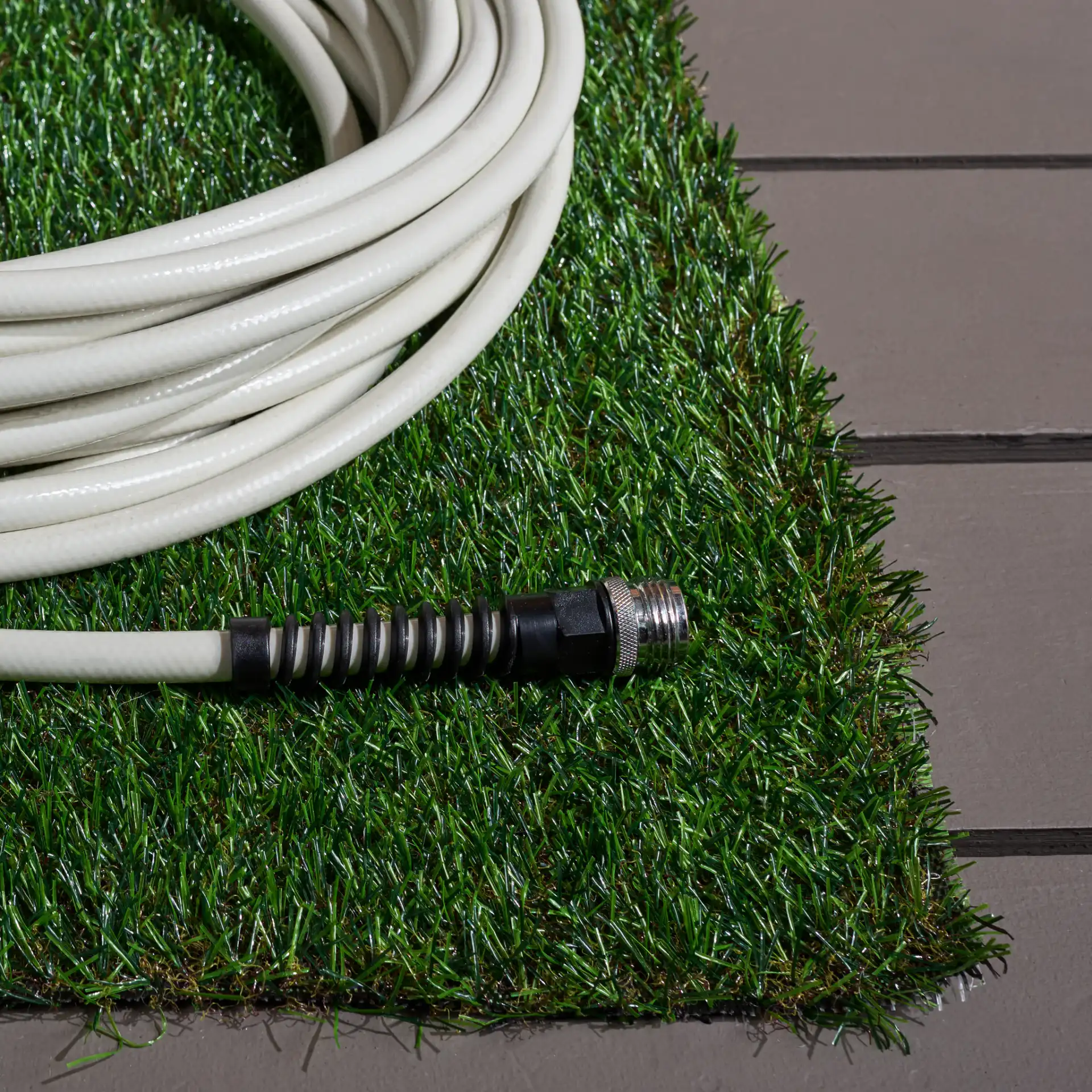 Turf Textured Solid Outdoor Rug in Natural / Green in a styled room