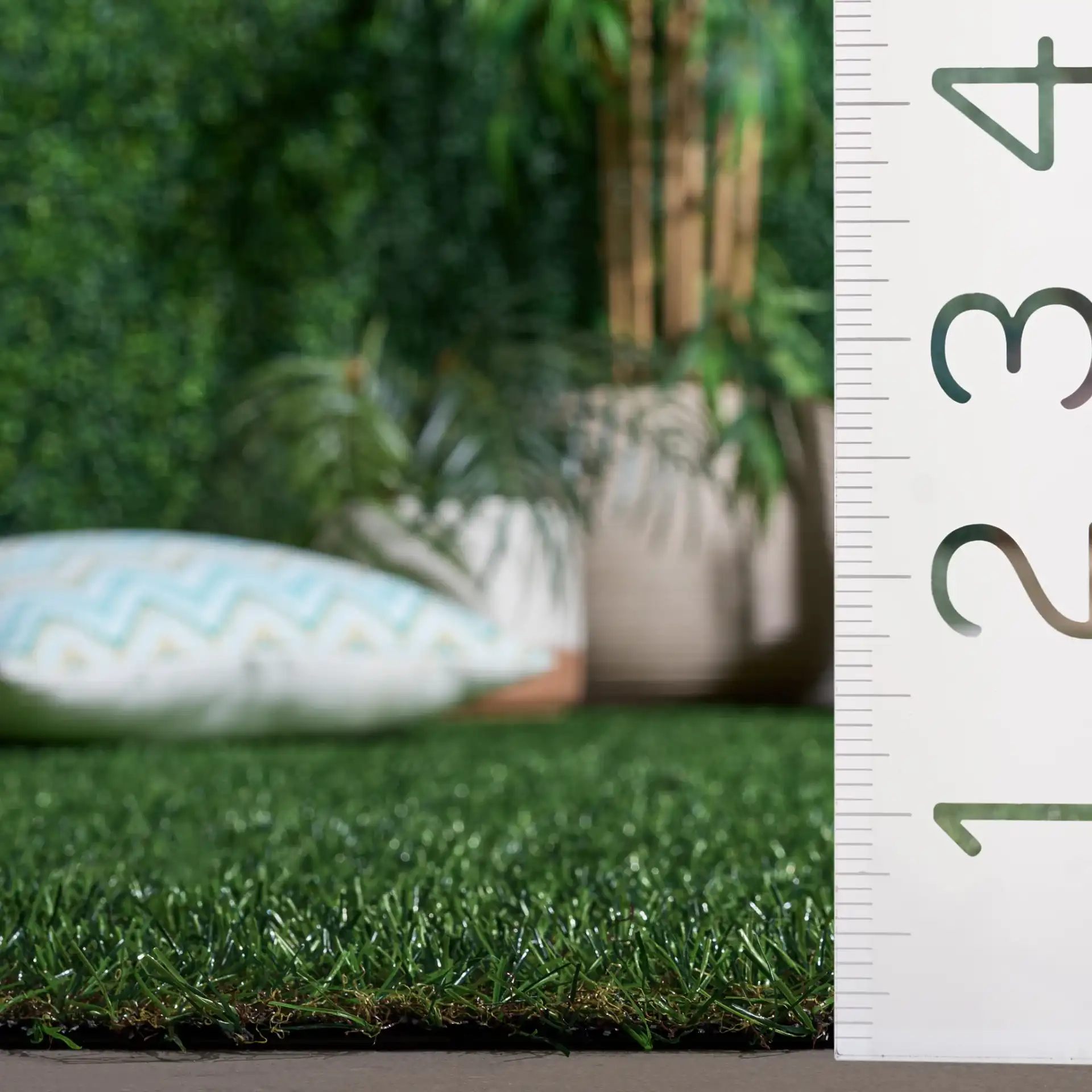 Turf Textured Solid Outdoor Rug in Natural / Green in a styled room