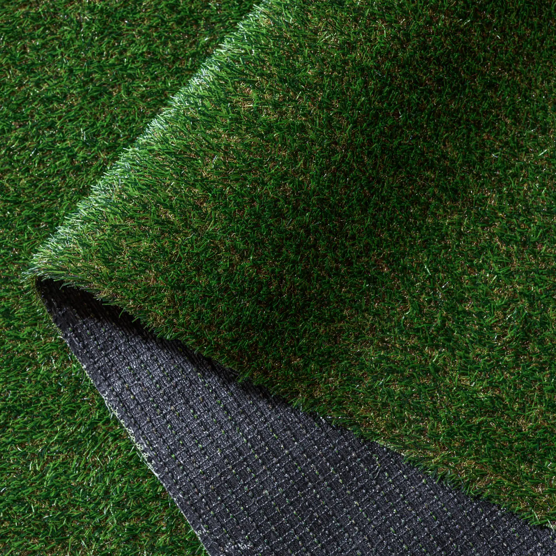 Turf Textured Solid Outdoor Rug in Natural / Green in a styled room