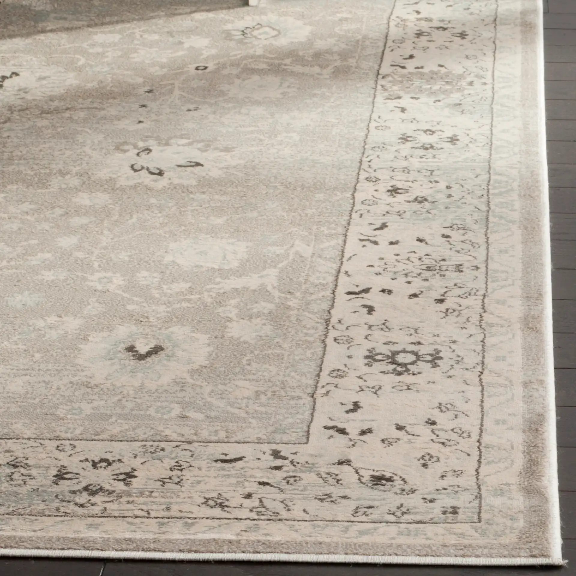 Vintage Distressed Bordered Rug in Light Gray / Ivory in a styled room