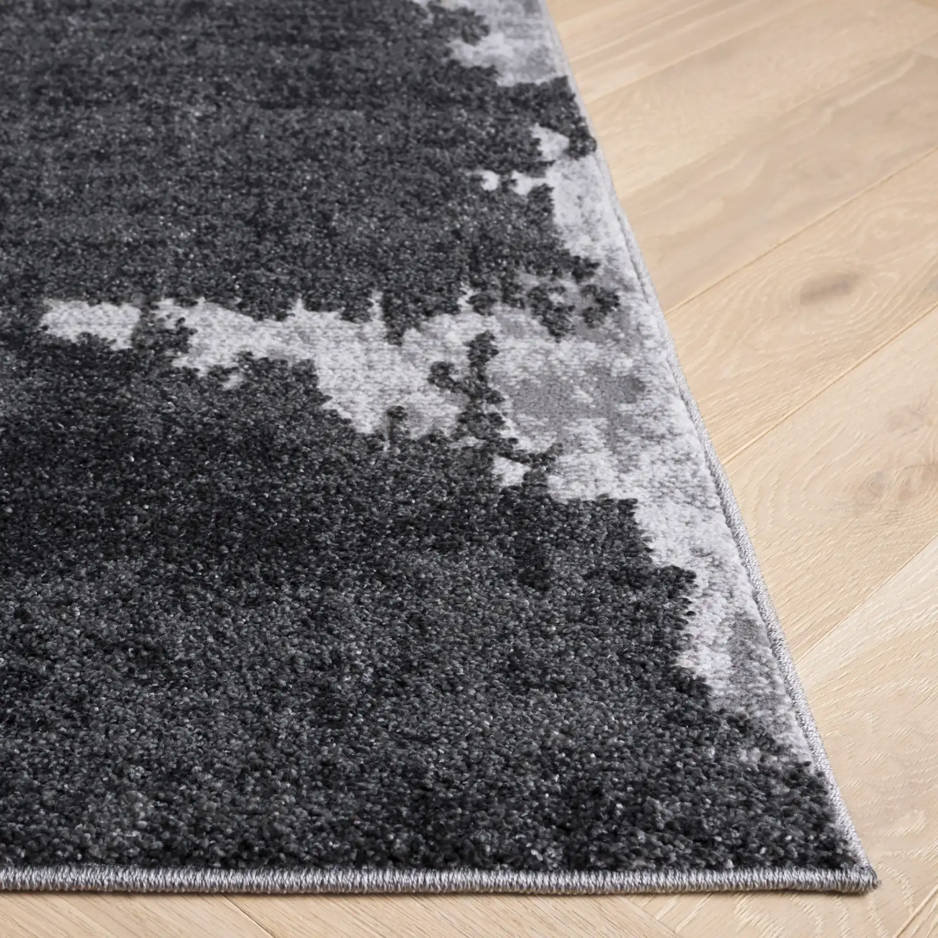 Wave Painterly Abstract Rug in Gray / Light Gray in a styled room