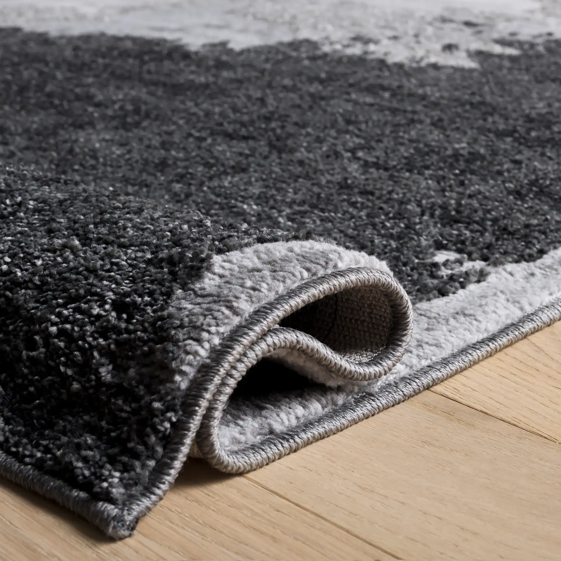 Wave Painterly Abstract Rug in Gray / Light Gray in a styled room
