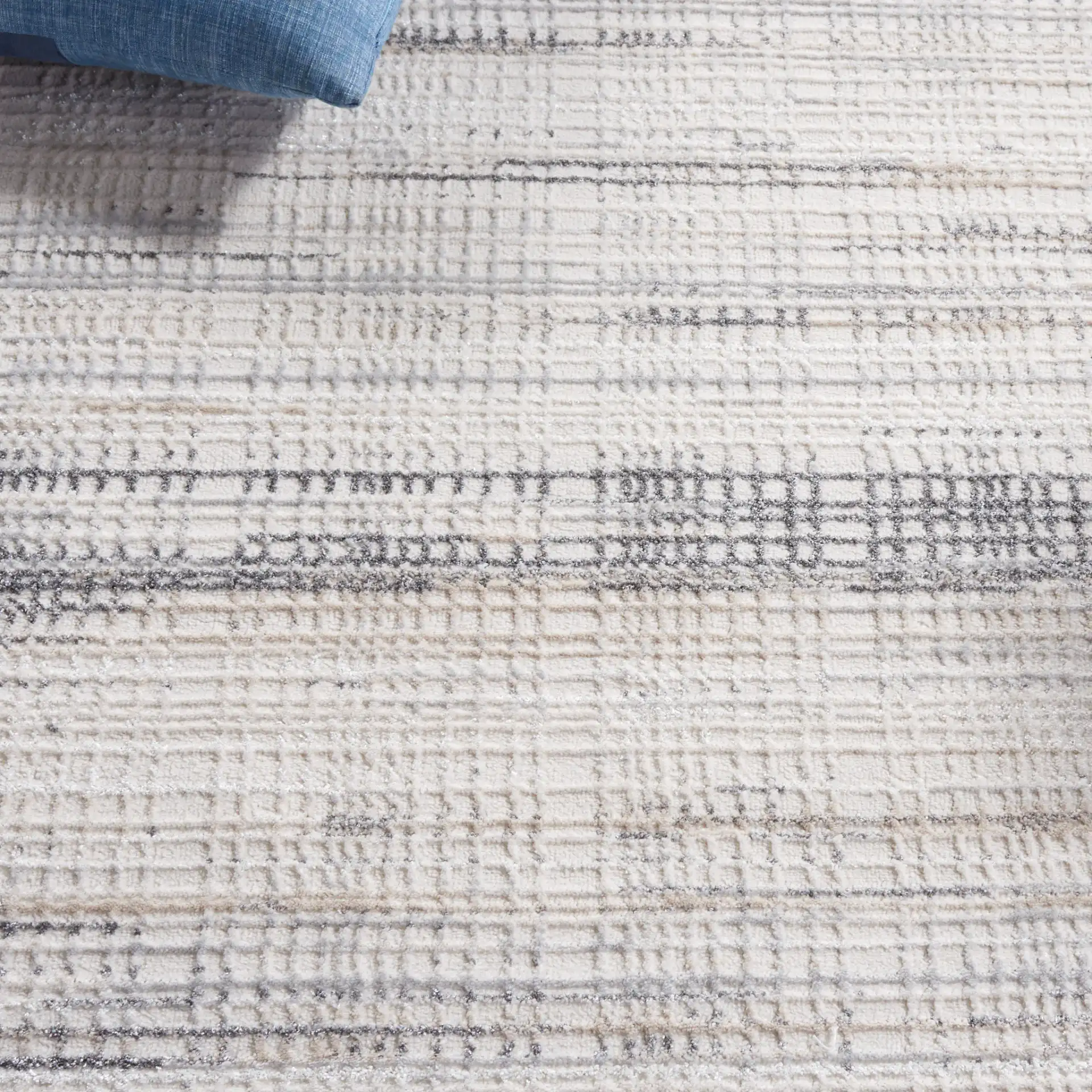 Whisper Linear Stripe Rug in Ivory / Gray in a styled room