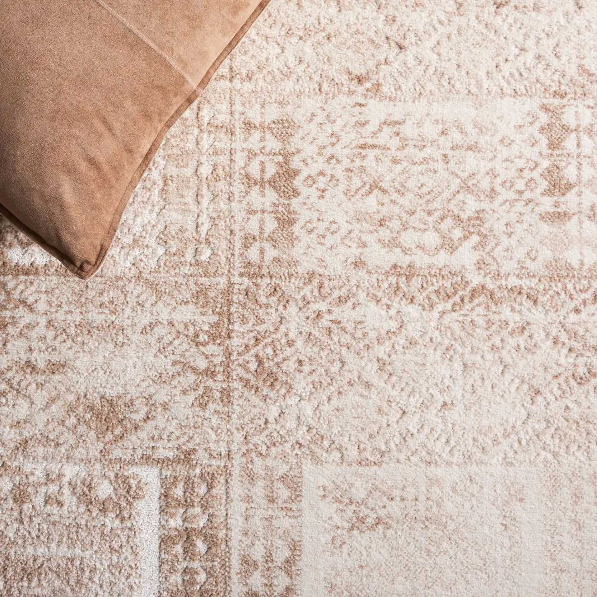 Whisper Distressed Patchwork Rug in Beige / Light Beige in a styled room