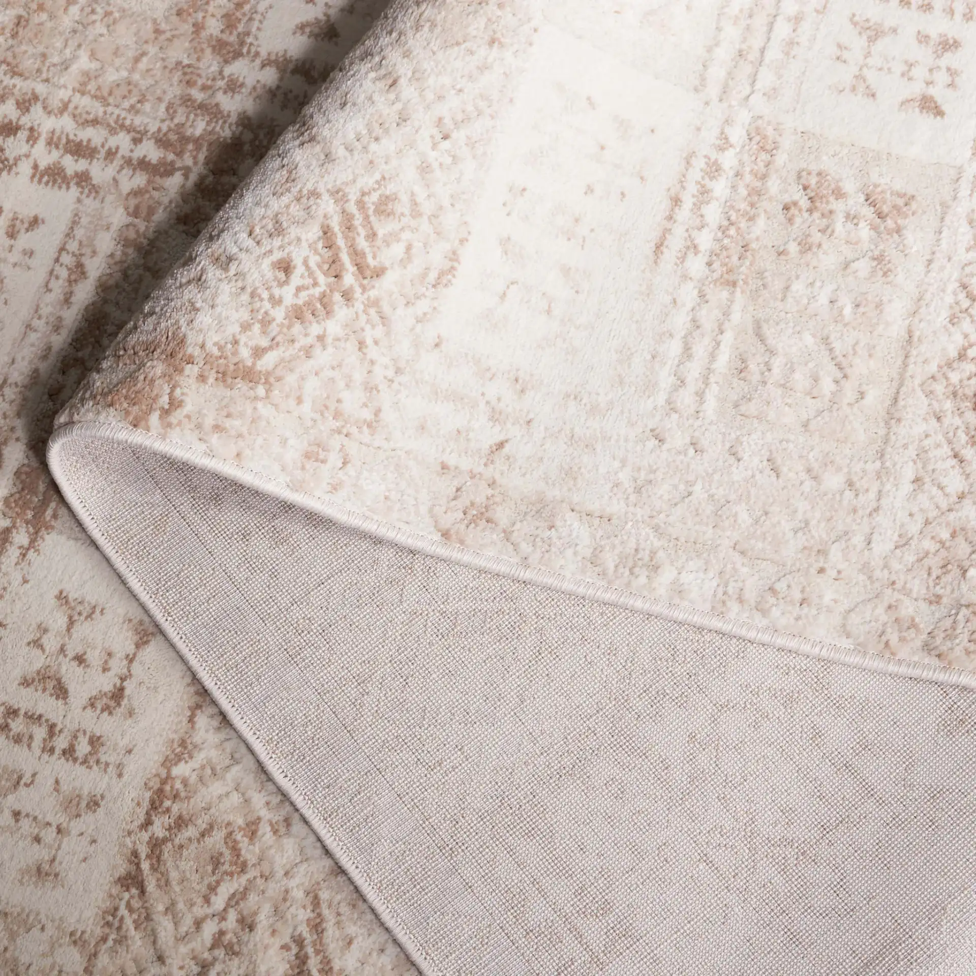 Whisper Distressed Patchwork Rug in Beige / Light Beige in a styled room