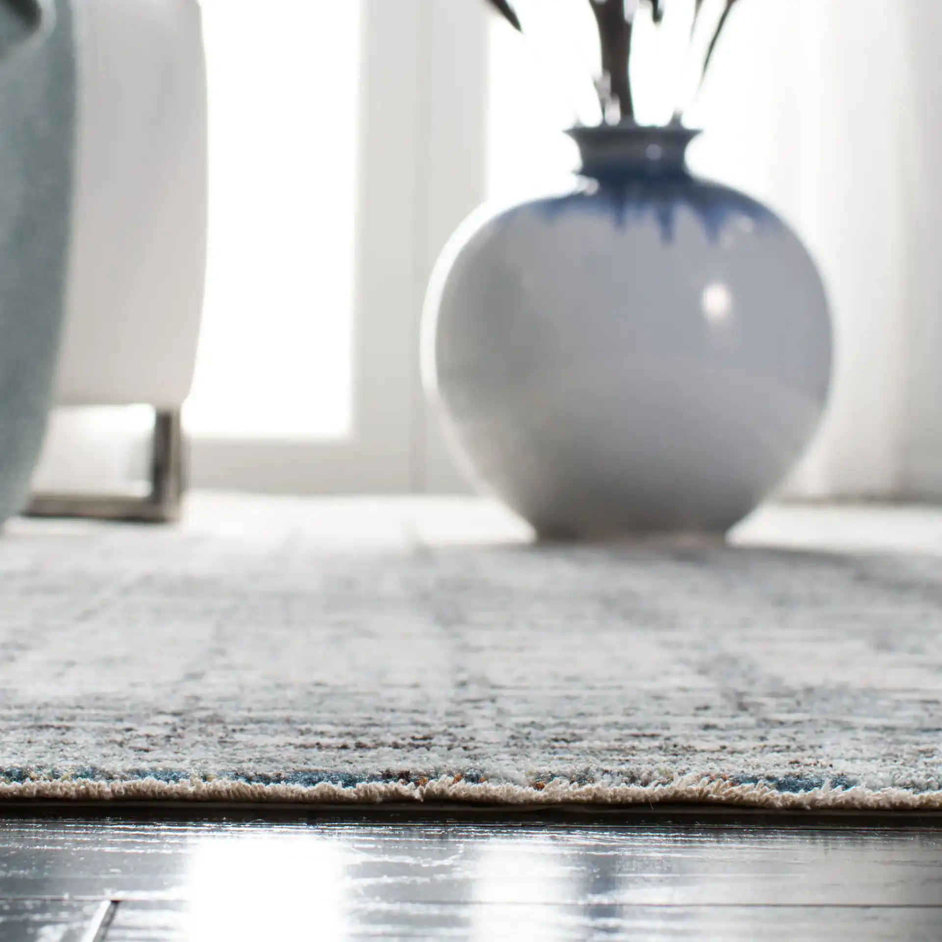 Winston Distressed Grid Rug in Gray / Beige in a styled room